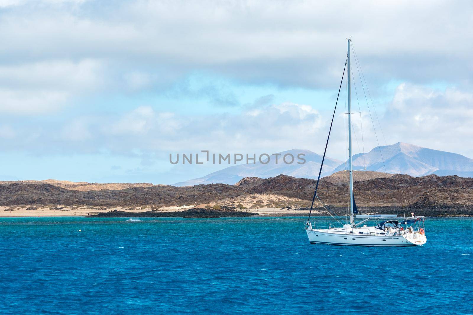 Corralejo, Fuerteventura, Spain: 2020 September 30: Boat in the sea near Corralejo in Fuerteventura in the Canary Islands in Spain.