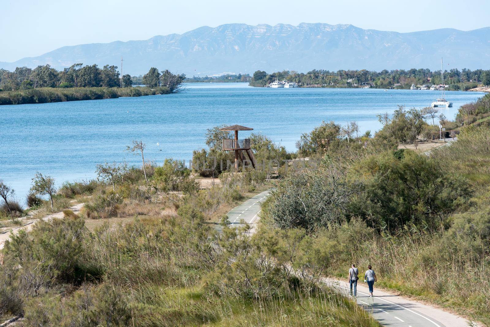 Ebro Delta, Spain: 2020 September: PEople wlaking in the Ebro River in summer in the port.