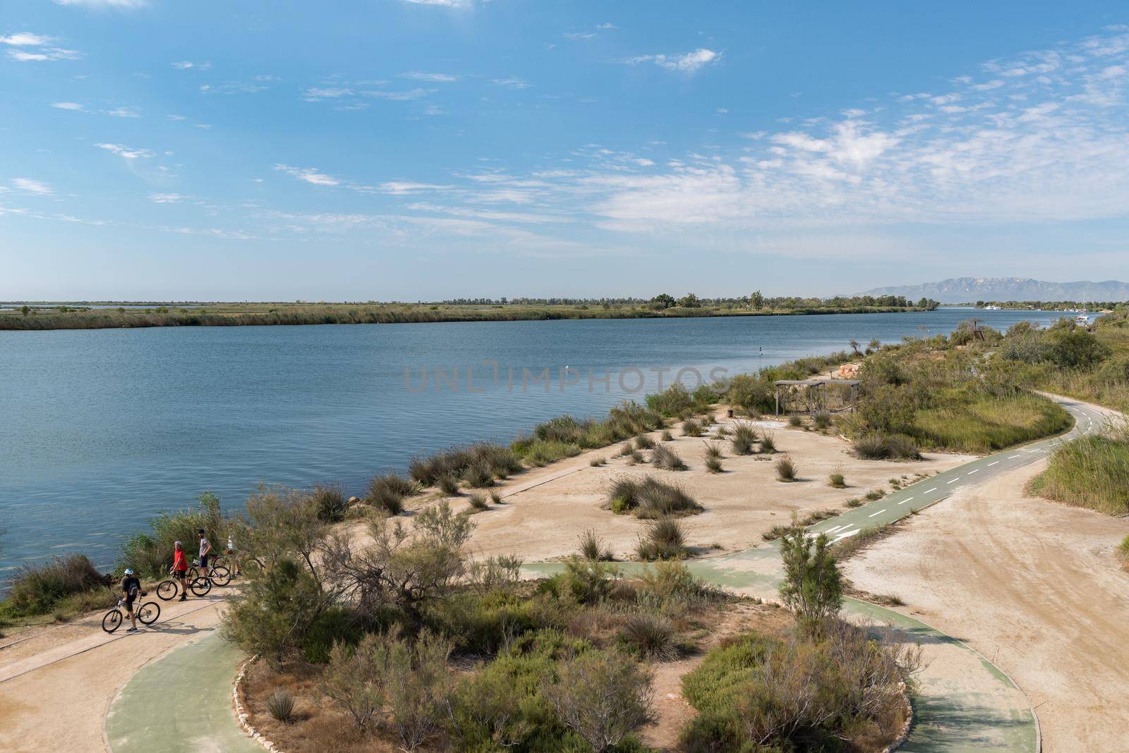 Ebro Delta, Spain: 2020 September: People in bike in the Ebro River in summer in the port.