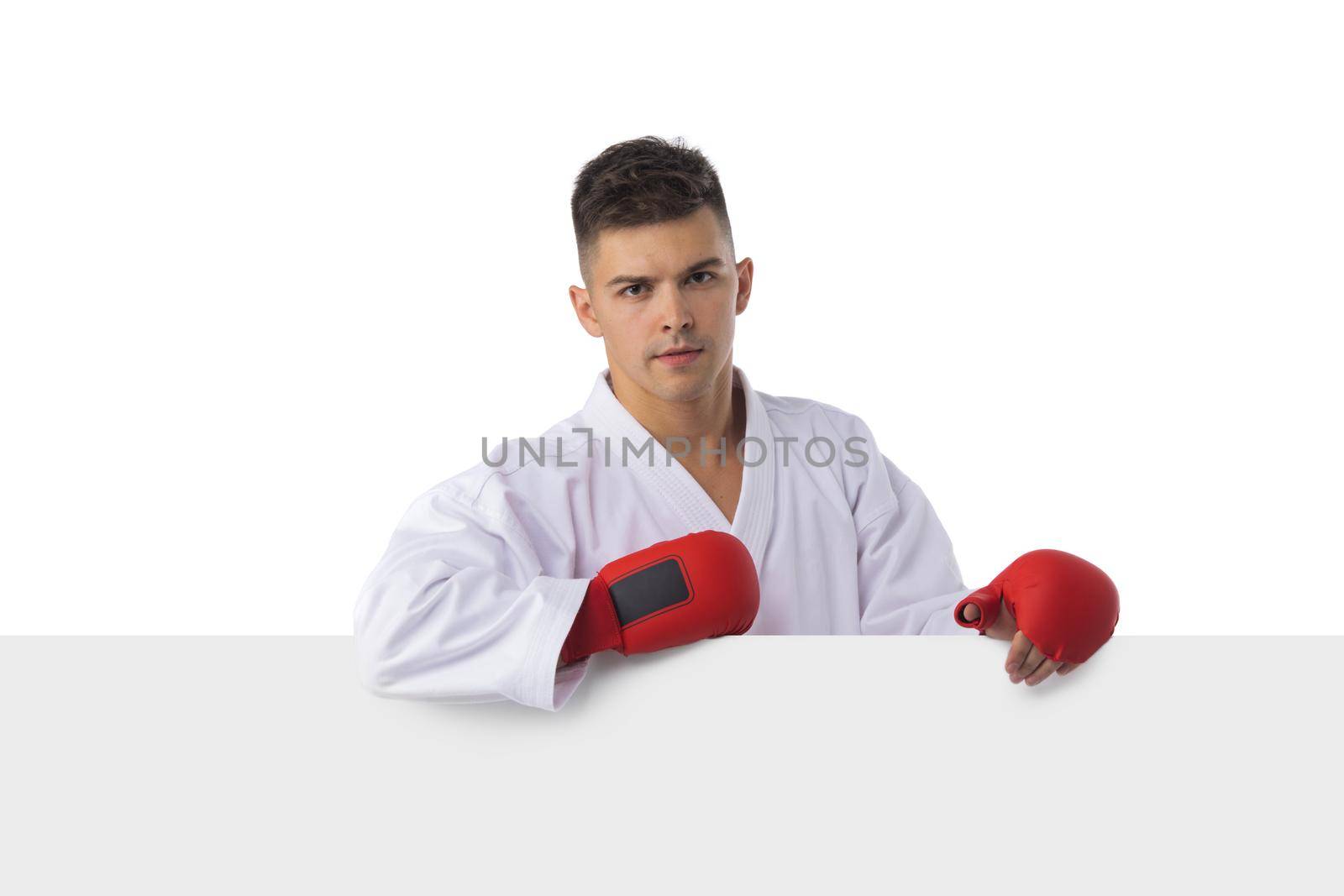 Man fighter training taekwondo with blank banner isolated on white background