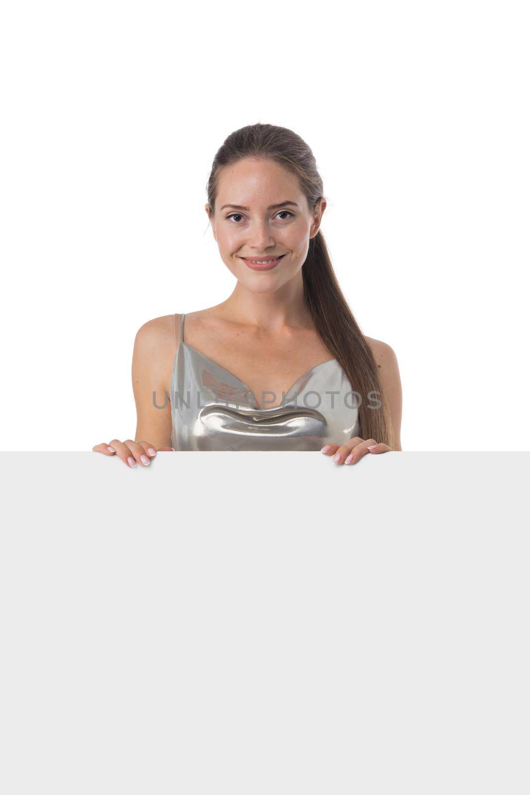 Young party girl in silver dress displaying a banner isolated over white background