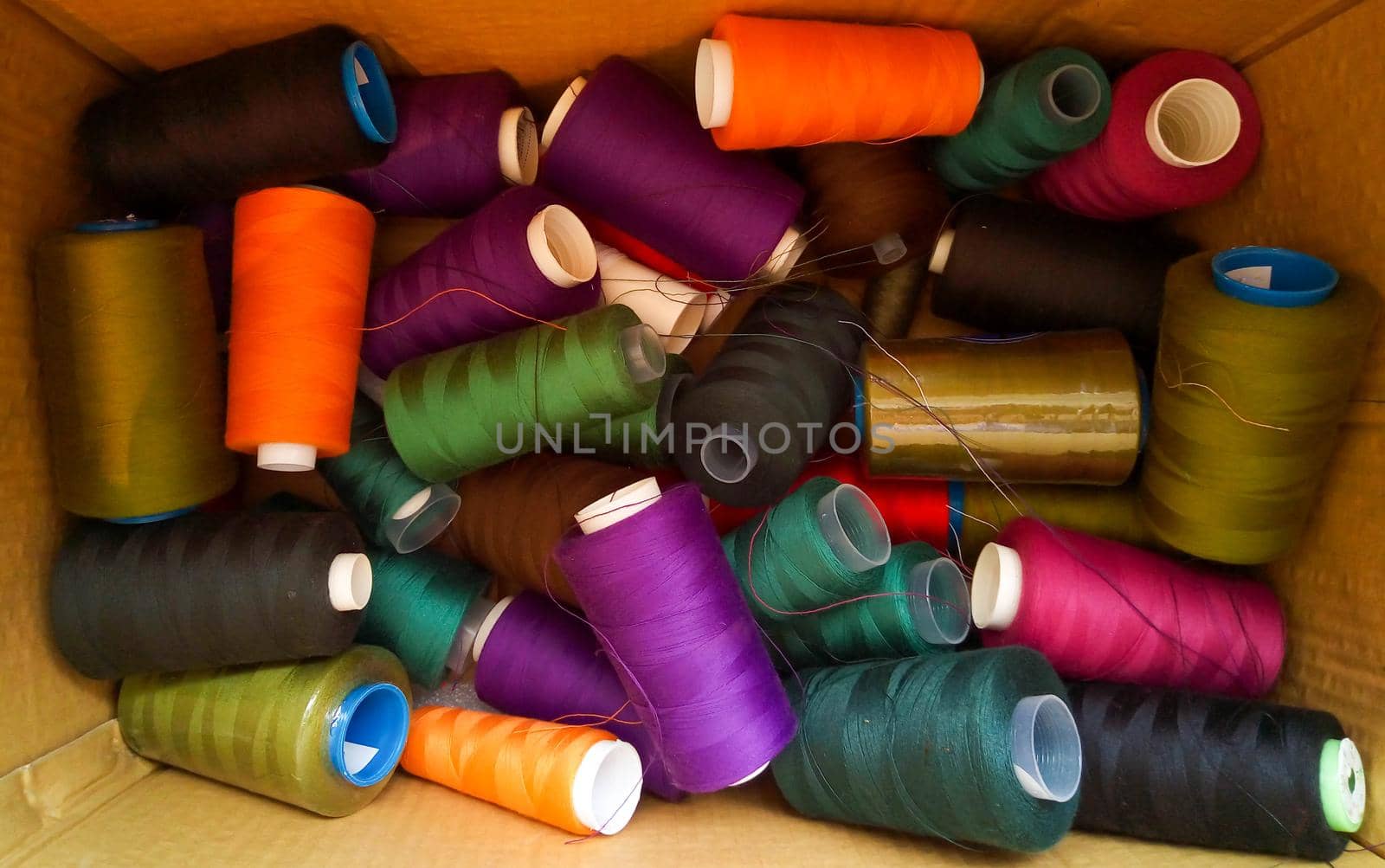 Sewing multicolored threads are in the box.