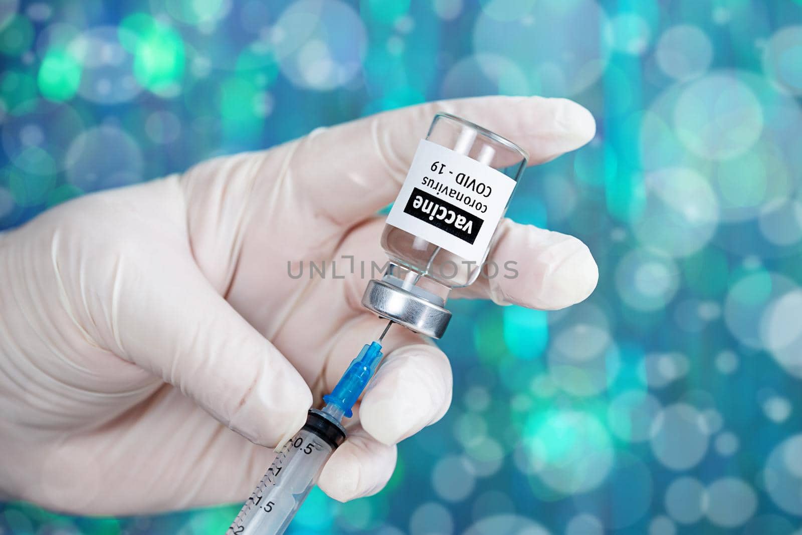 Coronavirus Covid-19 Vaccine. Doctor filling syringe injection with vaccine by galinasharapova