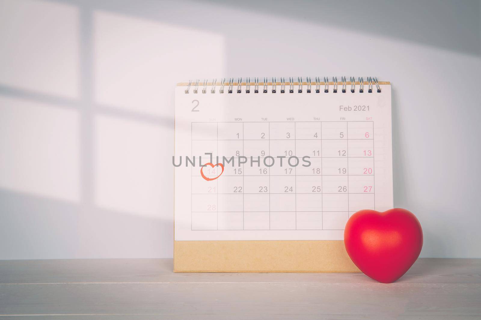 Calendar and heart shape with memo 14 February Valentine day on desk, reminder for surprise of love, romance and sweet, celebration and decoration, date and planner, nobody, top view, holiday concept. by nnudoo