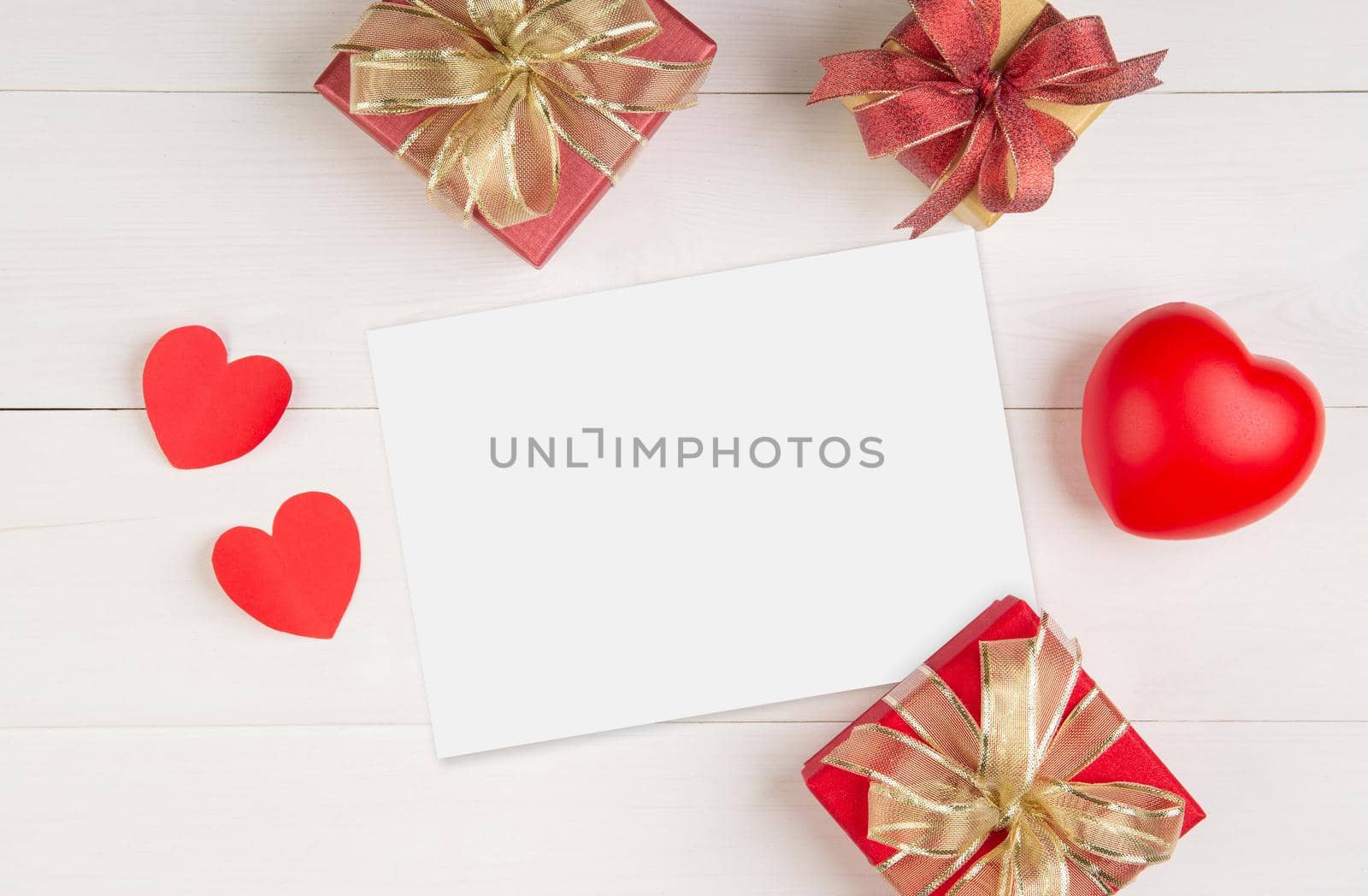 Blank postcard size a5 and letter and gift box and heart shape on wooden table, mockup greeting card and template, decoration with romantic, celebration Valentine day and holiday concept.