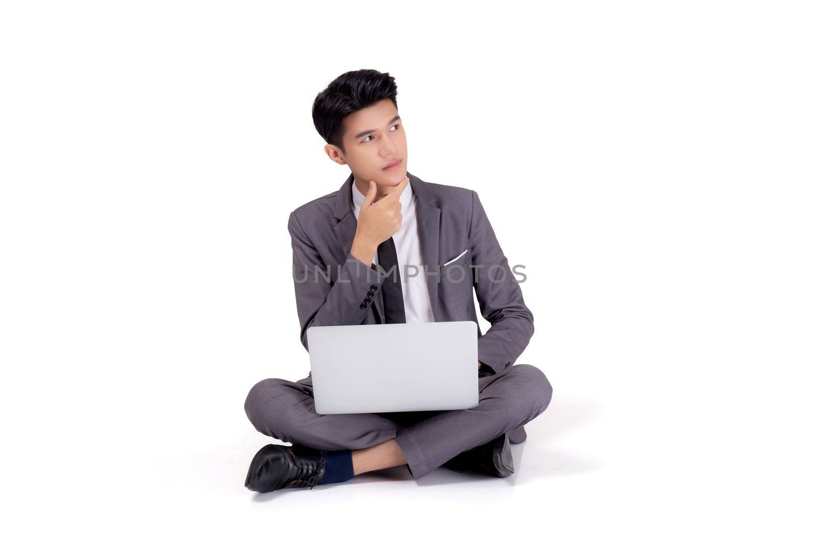 Young asian business man sitting thinking and work on laptop computer to internet online isolated on white background, businessman with notebook, freelance with success, marketing and communication.