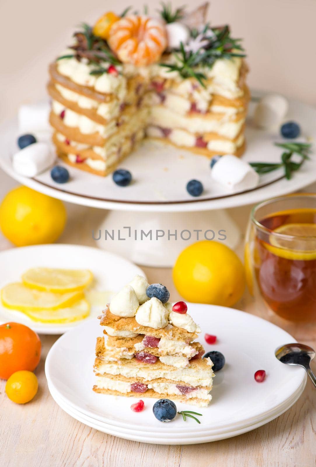 Lemon cakes, pies with a cup of tea on gray background. Top view. Copy space. Cafe menu.