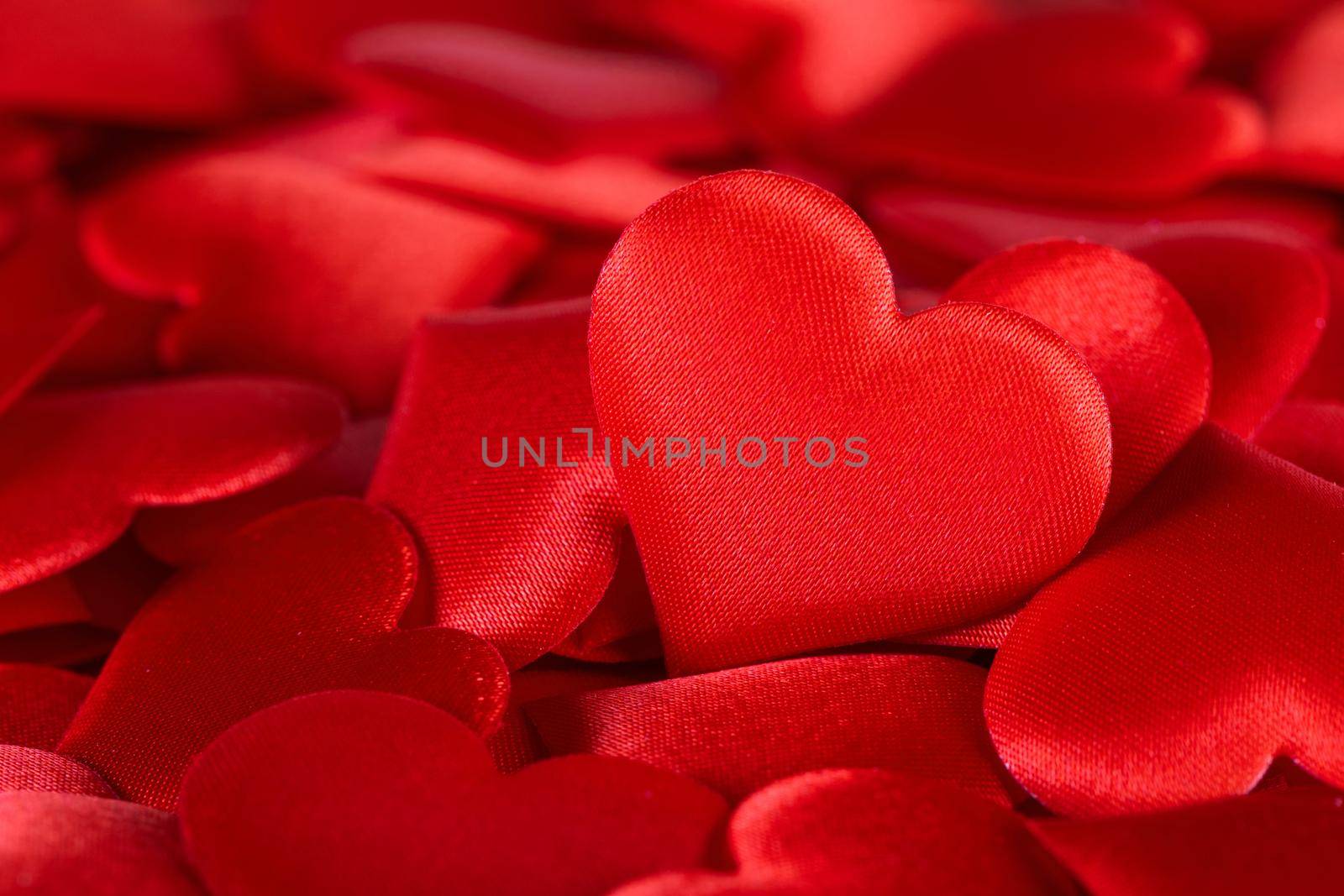 Valentine's day many red silk hearts background, love concept