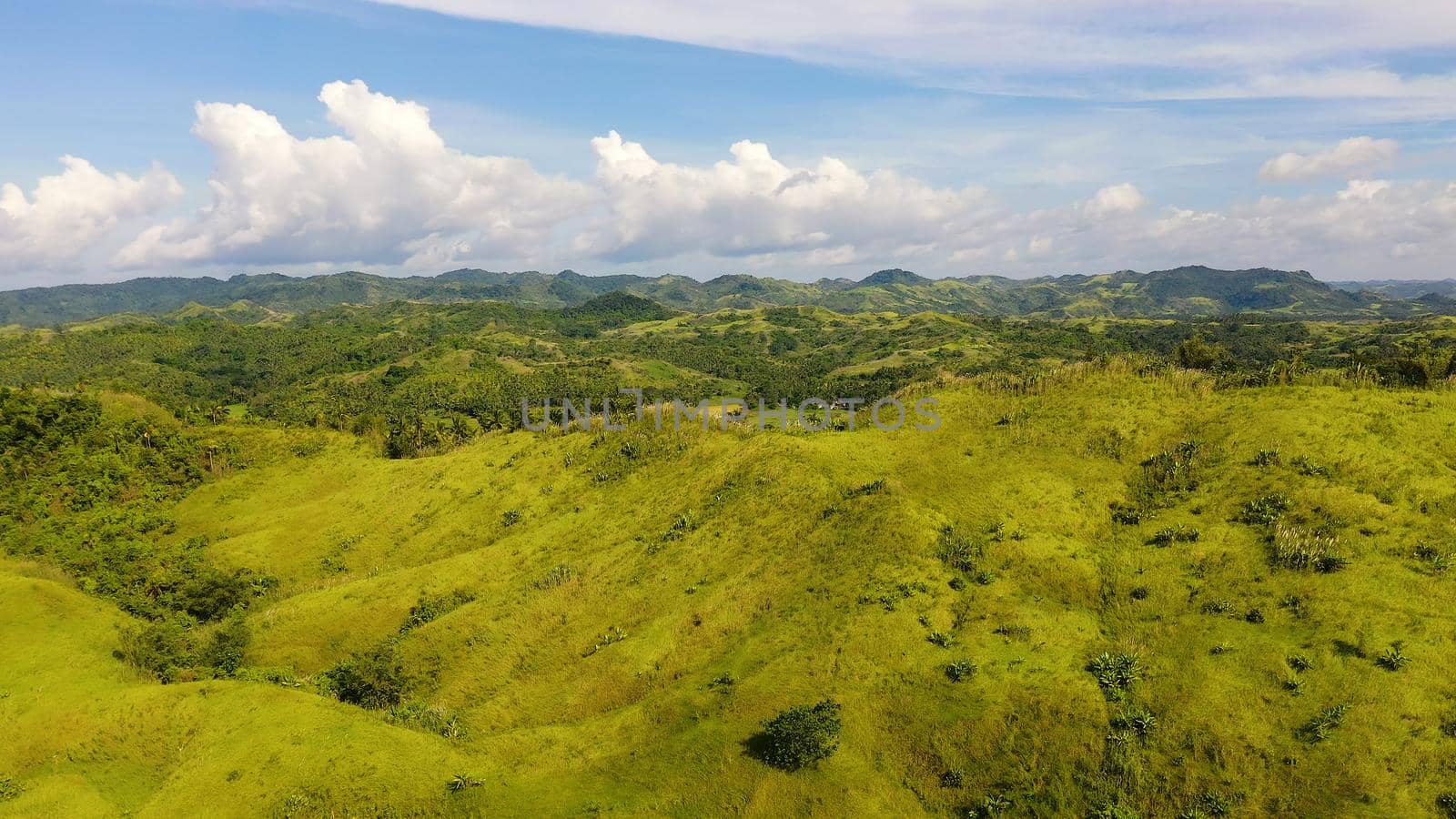 The nature of the Philippine Islands, Samar. Mountains and hills in clear weather. Tropical landscape with green hills and rice fields, aerial view. Summer and travel vacation concept.