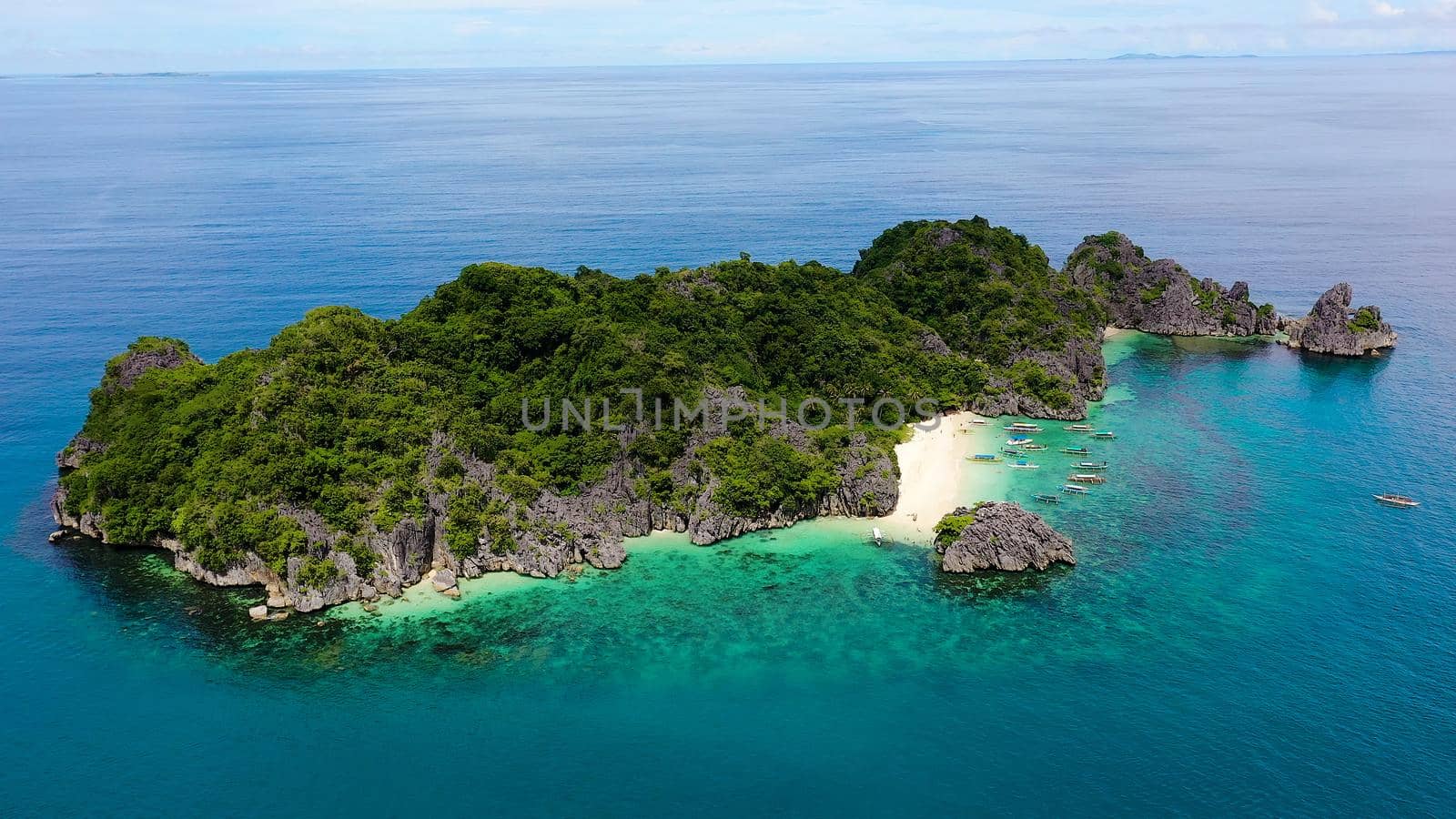 Travel concept: tropical sand beach and turquoise water view from the top. Lahos Island, Caramoan Islands, Philippines. Summer and travel vacation concept.