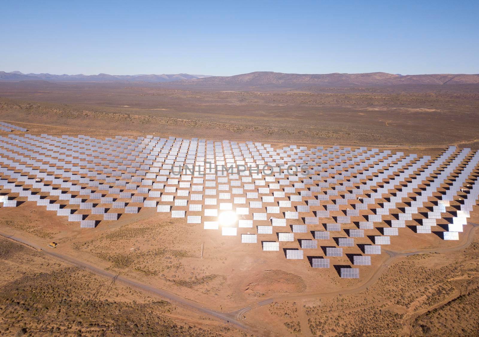 Aerial over solar panels in a dry landscape