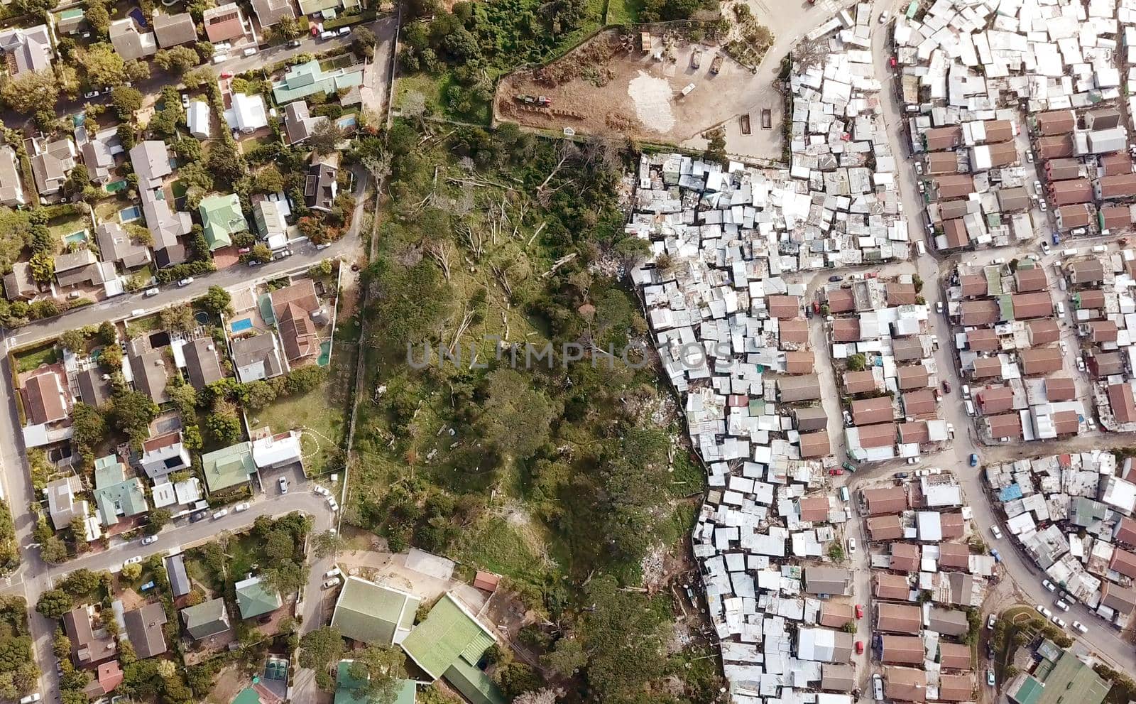 Aerial view over a township and wealthy suburb in South Africa by fivepointsix