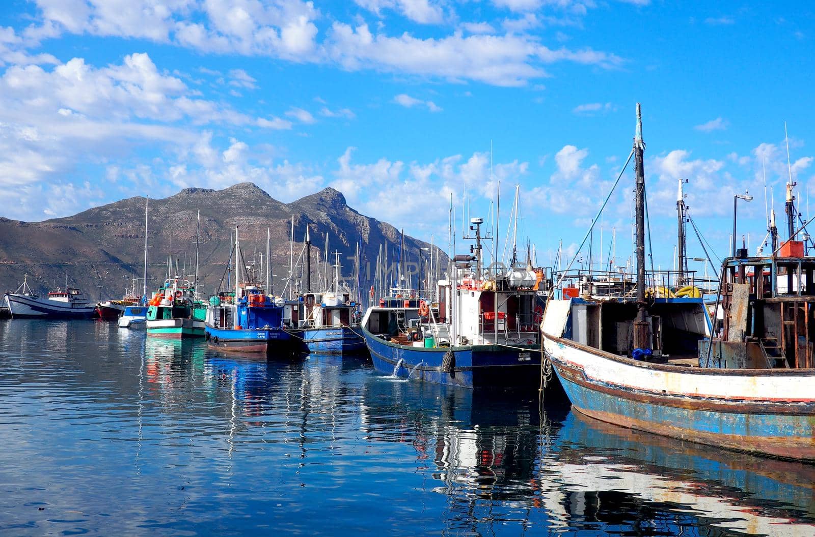 Small harbor with old fishing boats in South Africa by fivepointsix