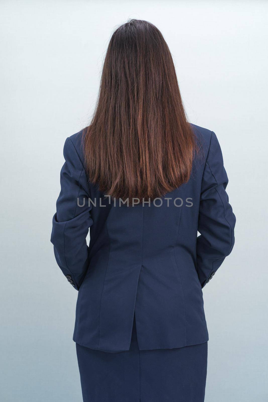 Asian women wearing a suit in studio from behind