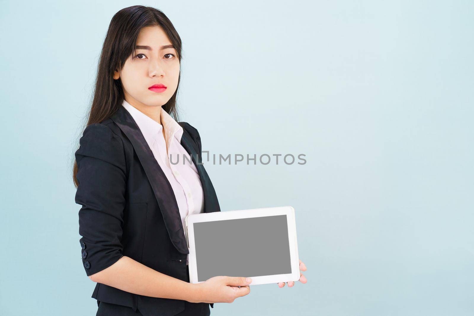 Young women in suit holding her digital tablet by stoonn