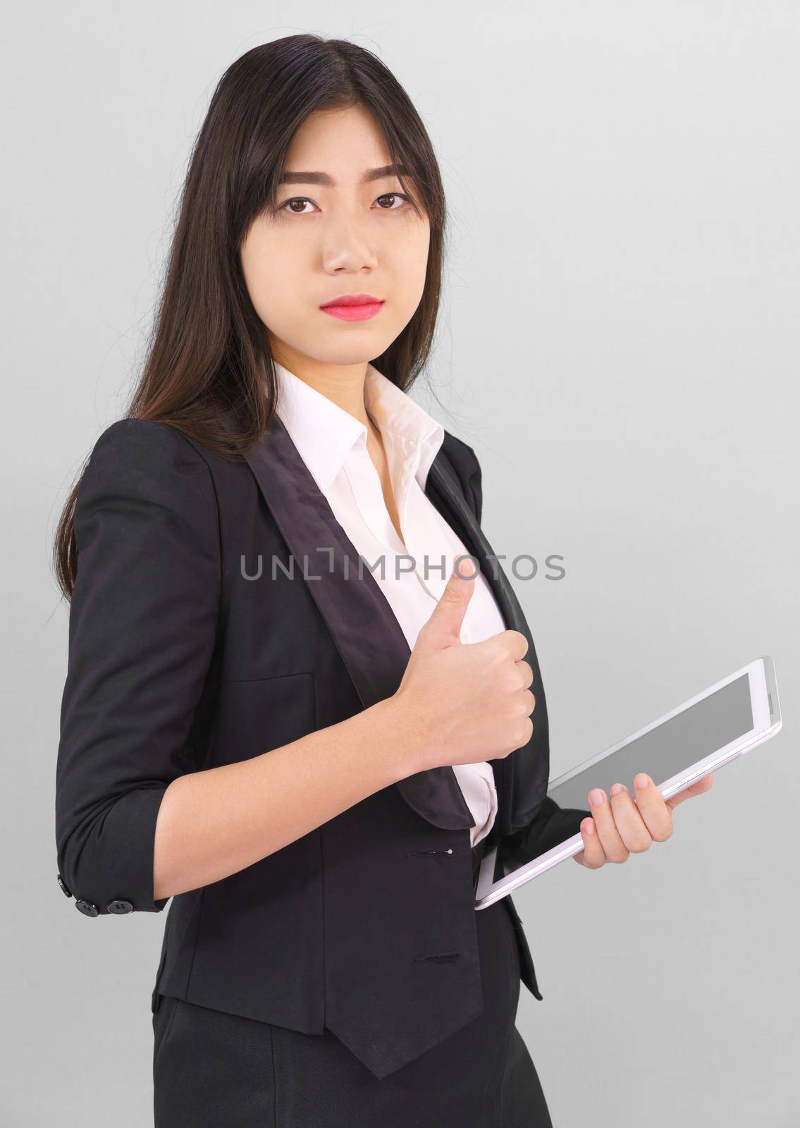 Young women standing in suit holding her digital tablet computor