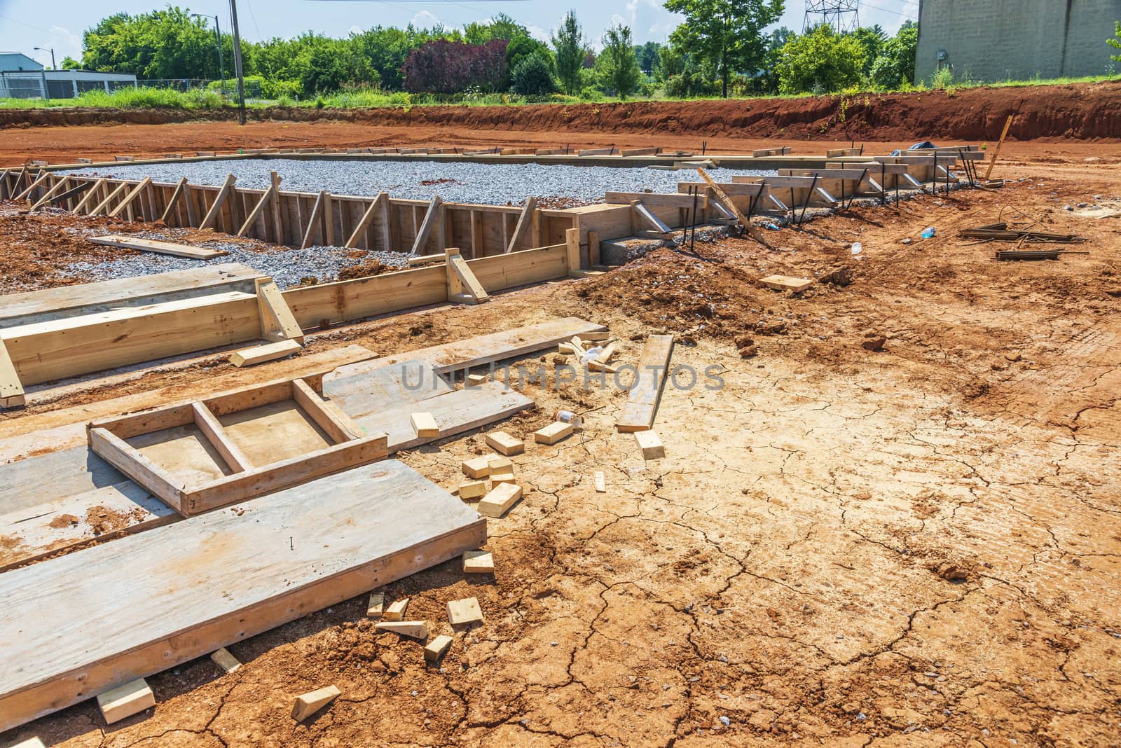 Horizontal shot of a construction site with an area prepared for the pouring of a concrete slab for a new commercial building.