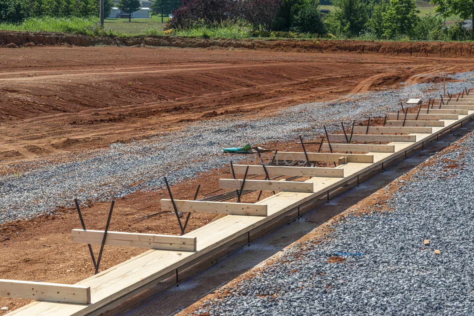 Horizontal shot of a construction site with a wooden frame ready for a concrete slab to be poured.