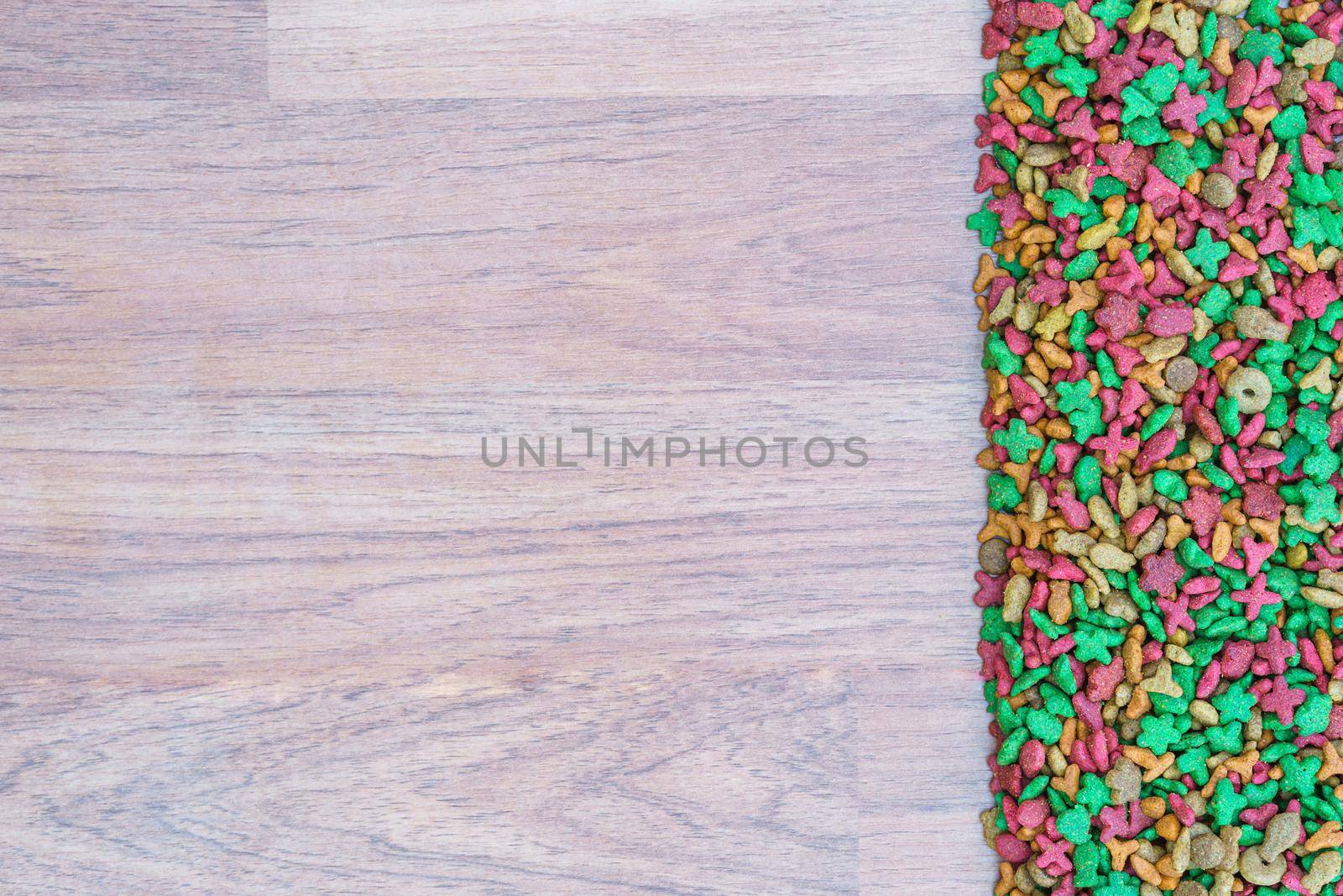 Top view dry cat food on wooden background with copy space