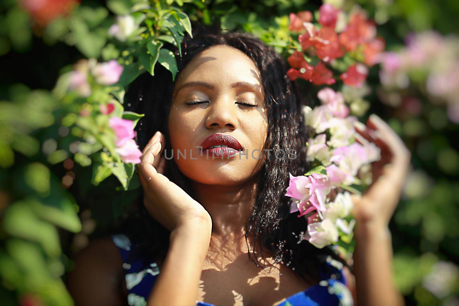 Cheerful young woman standing at outdoor with flower.