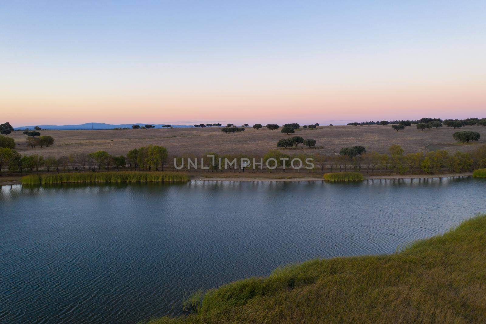 Lake drone aerial view at sunset in Alentejo, Portugal by Luispinaphotography