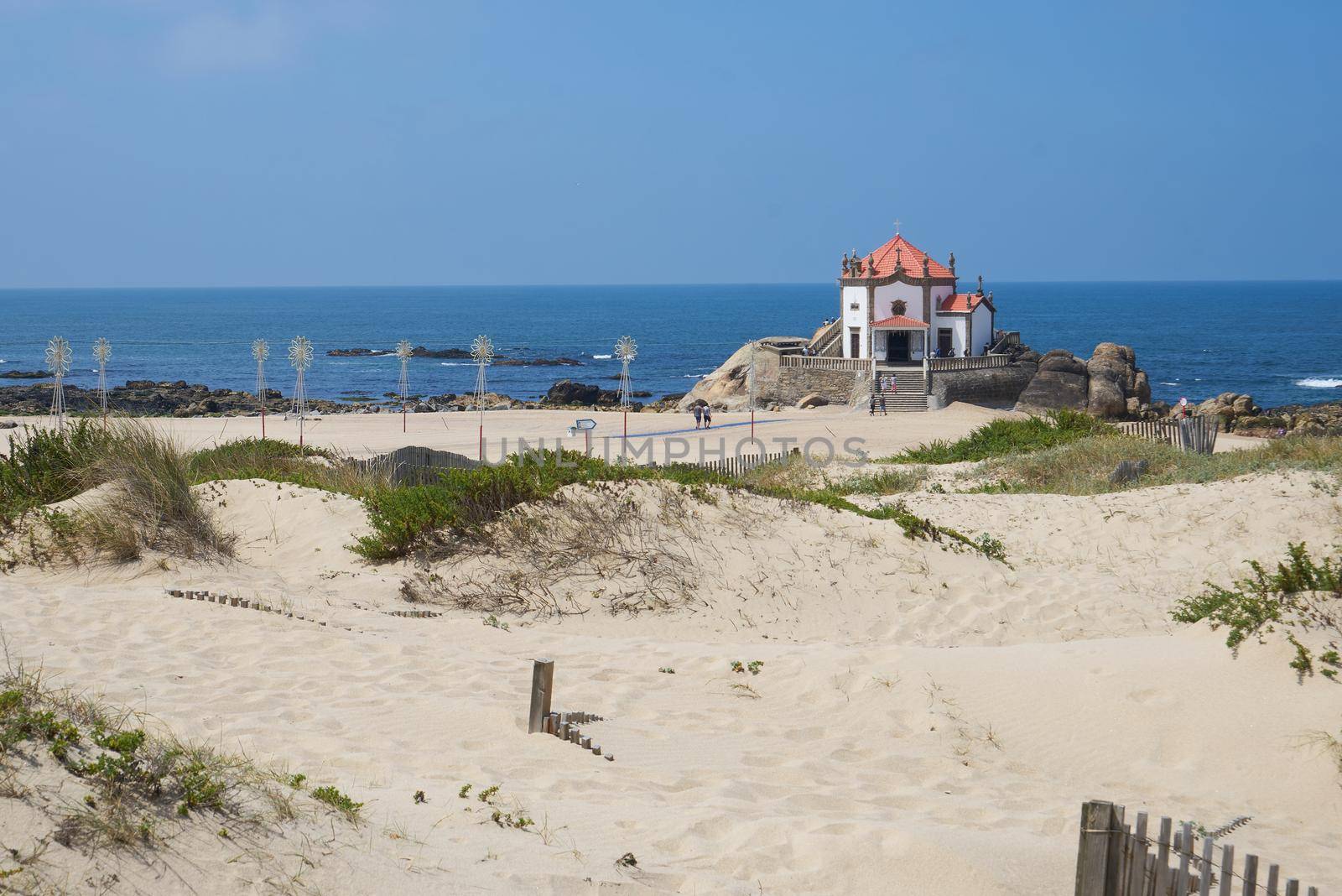 Beautiful chapel on the beach Capela do Senhor da Pedra in Miramar, in Portugal by Luispinaphotography