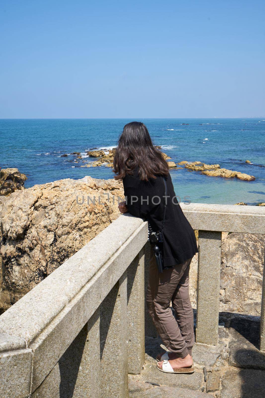 Woman in Praia do Senhor da Pedra beach, in Miramar Arcozelo, Portugal by Luispinaphotography