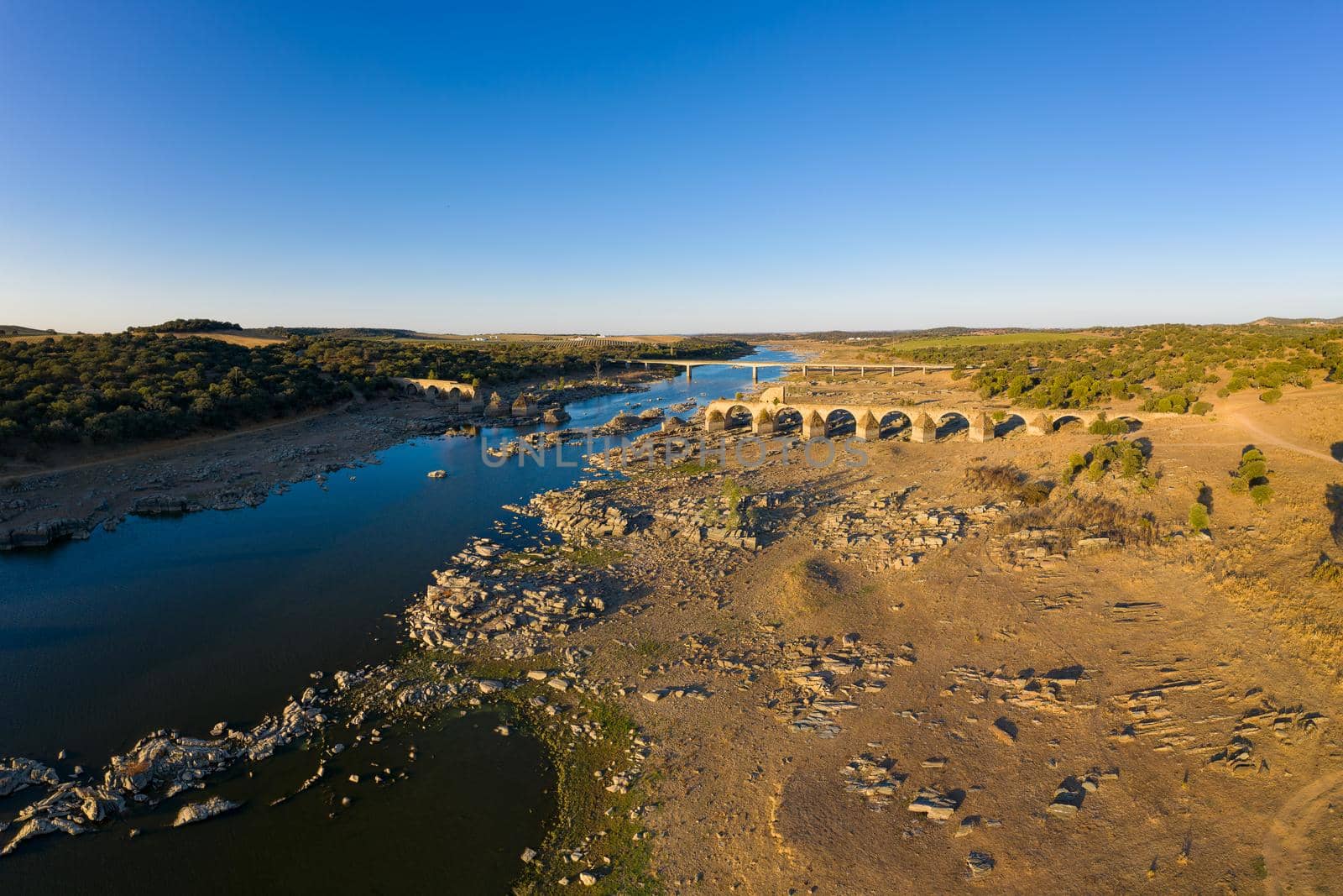 Destroyed abandoned Ajuda bridge drone aerial view, crossing the Guadiana river between Spain and Portugal by Luispinaphotography