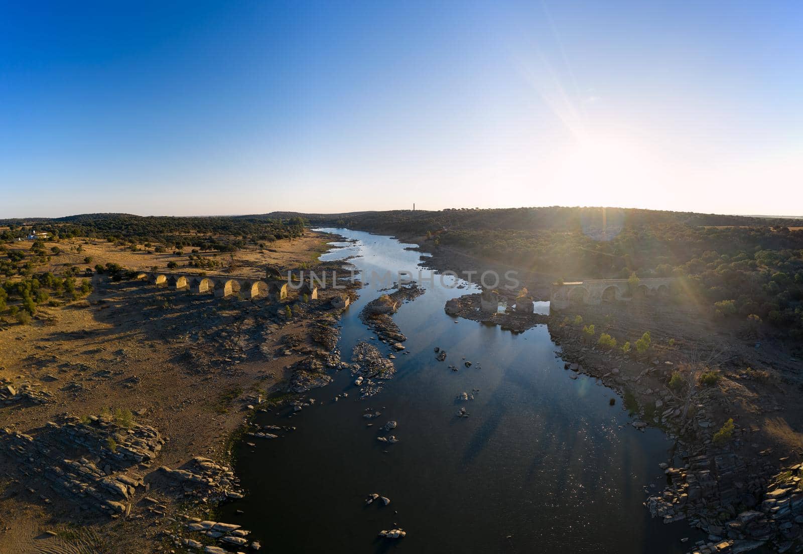 Destroyed abandoned Ajuda bridge drone aerial view, crossing the Guadiana river between Spain and Portugal by Luispinaphotography