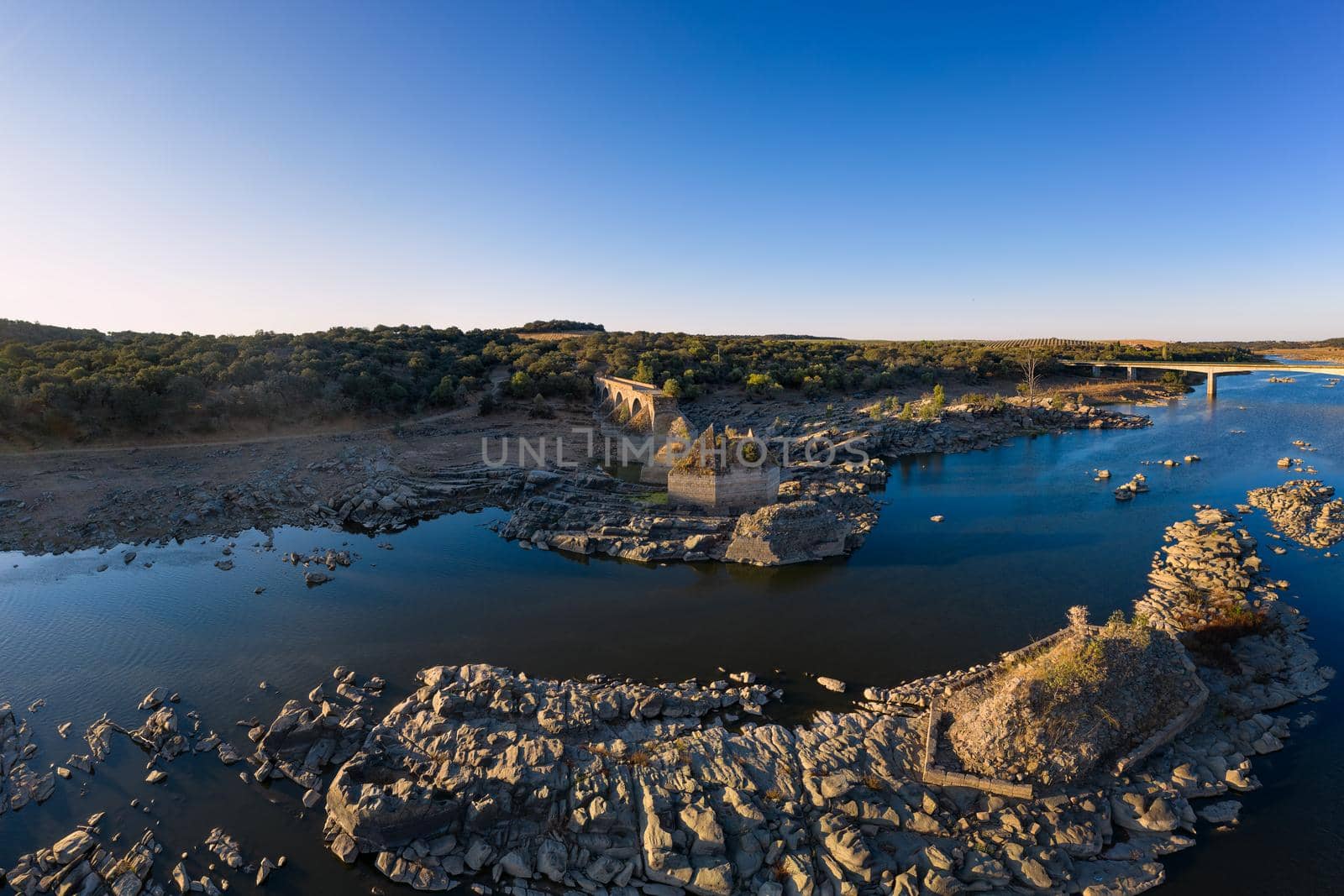 Destroyed abandoned Ajuda bridge drone aerial view, crossing the Guadiana river between Spain and Portugal by Luispinaphotography