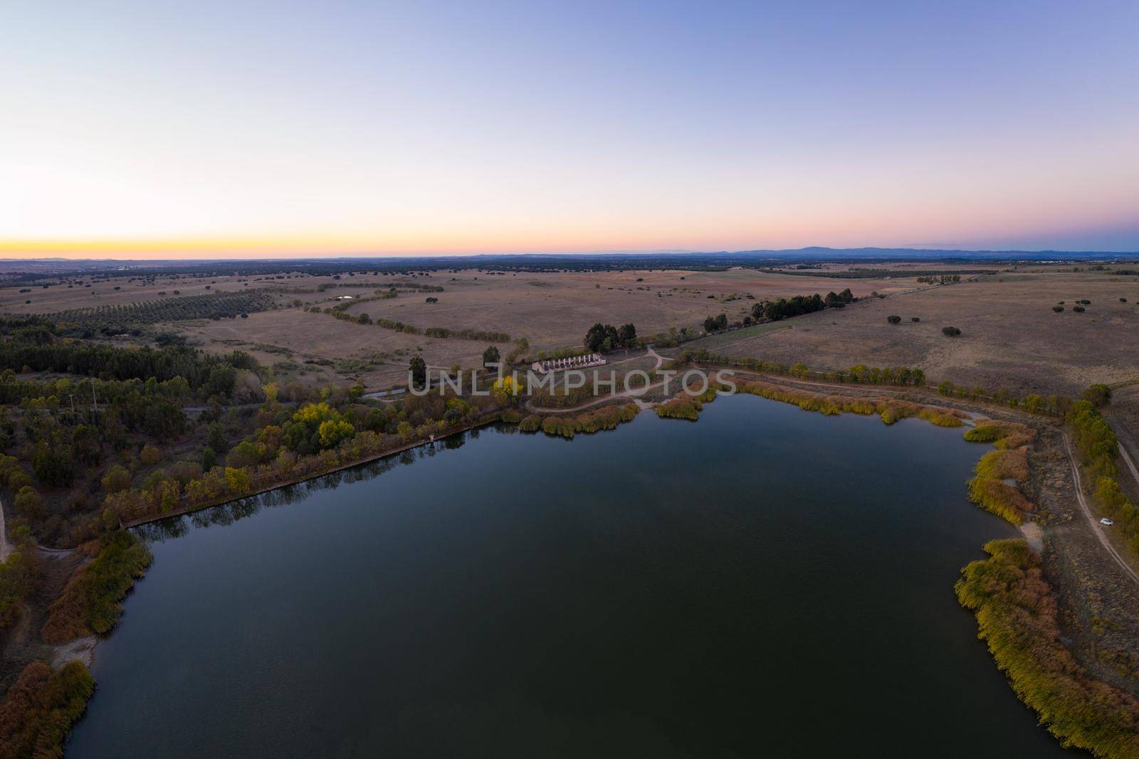 Lake drone aerial view at sunset in Alentejo, Portugal by Luispinaphotography