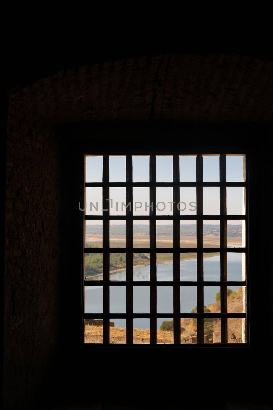 View of Juromenha castle with grid window in Alentejo landscape, in Portugal by Luispinaphotography