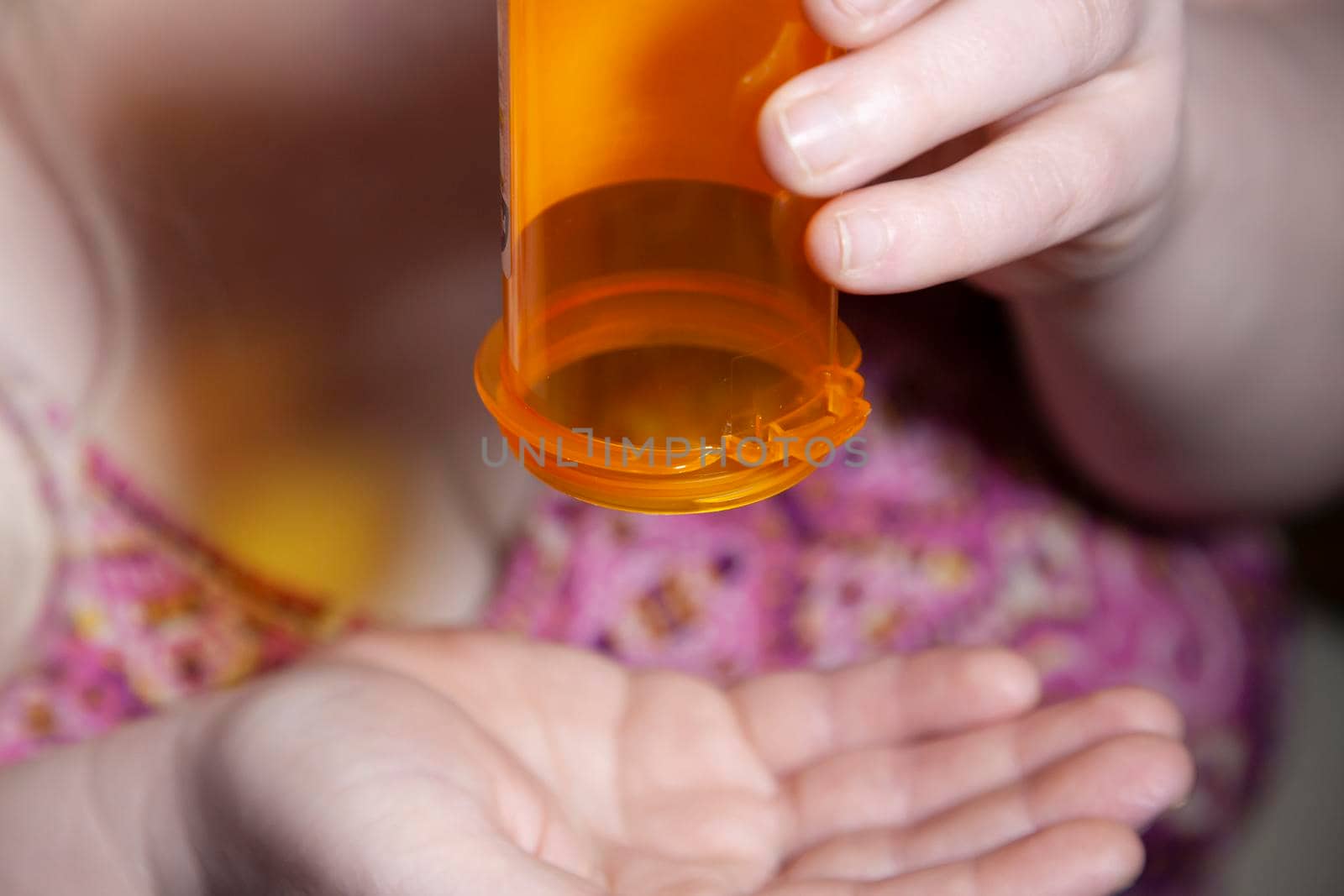 Woman dumping medication from a bottle into her hand