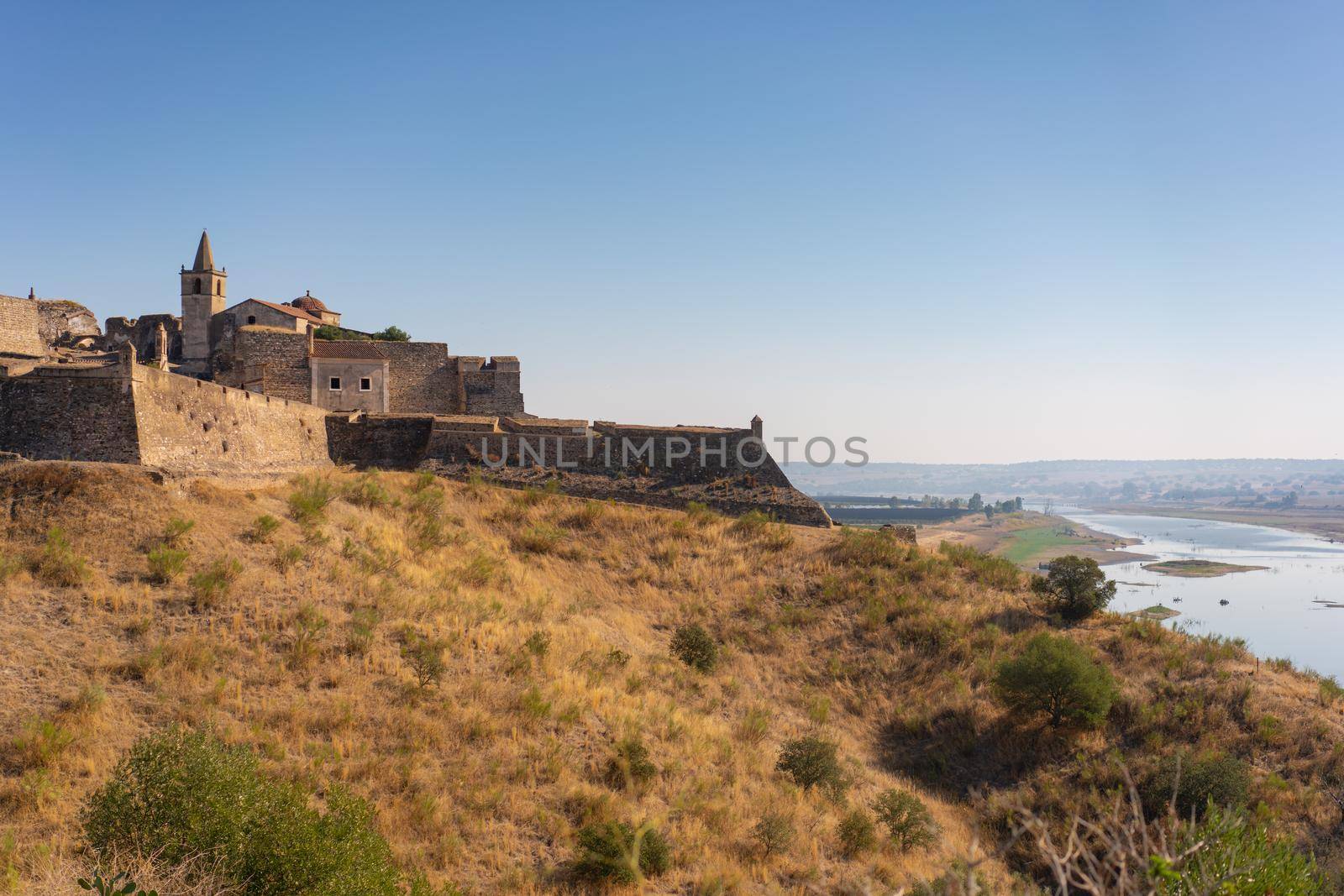 Juromenha castle and Guadiana river and border with Spain on the side of the river at sunrise, in Portugal by Luispinaphotography