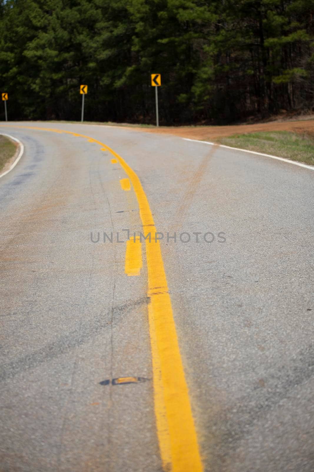 Highway that is about to curve and signs warning of the curve