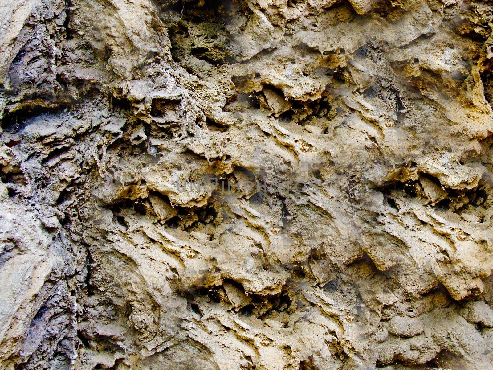 Rough and rough texture of the stone with depressions on the surface.Texture or background