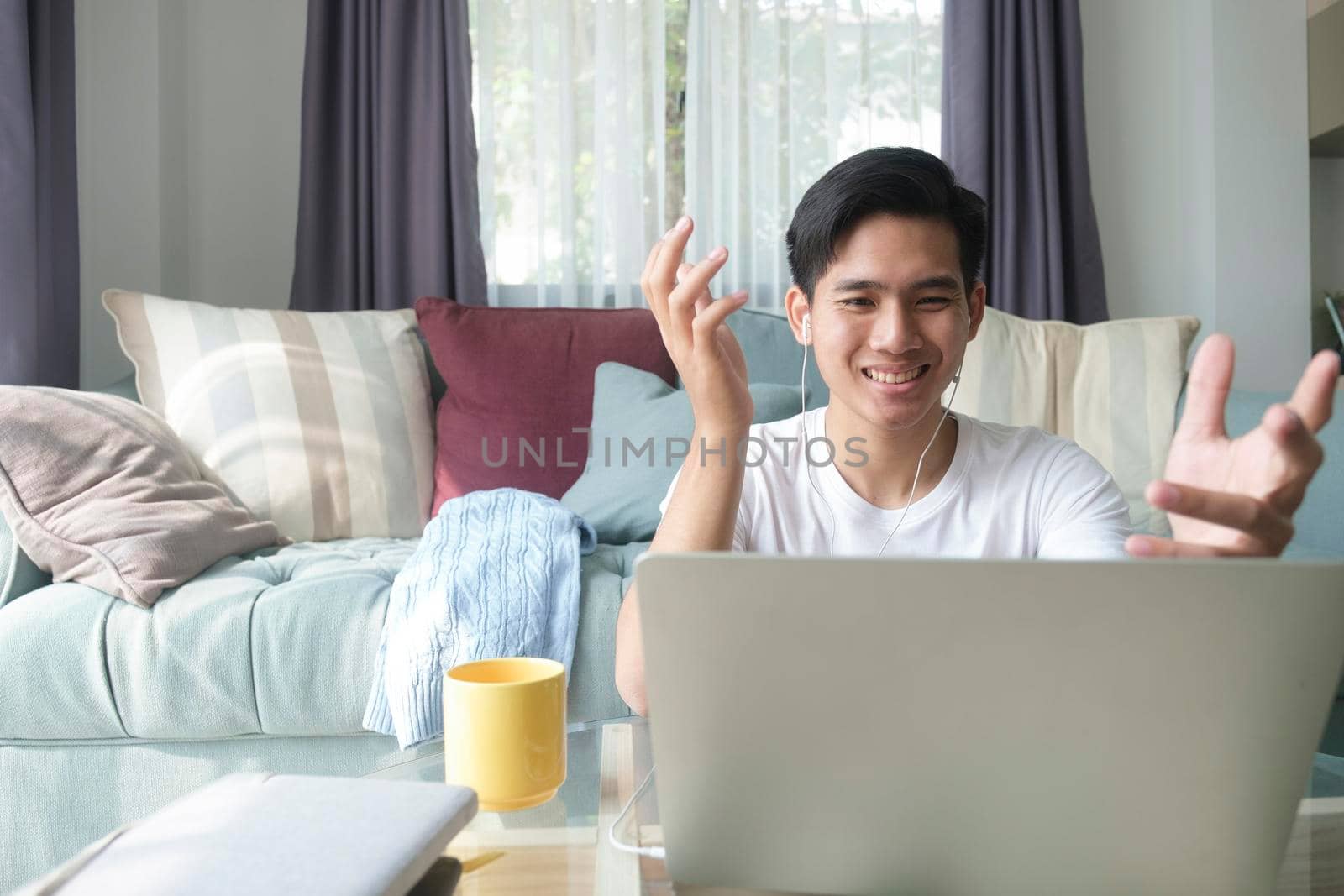 Young man working and learning online at home. Young man video call conference online with his colleagues.