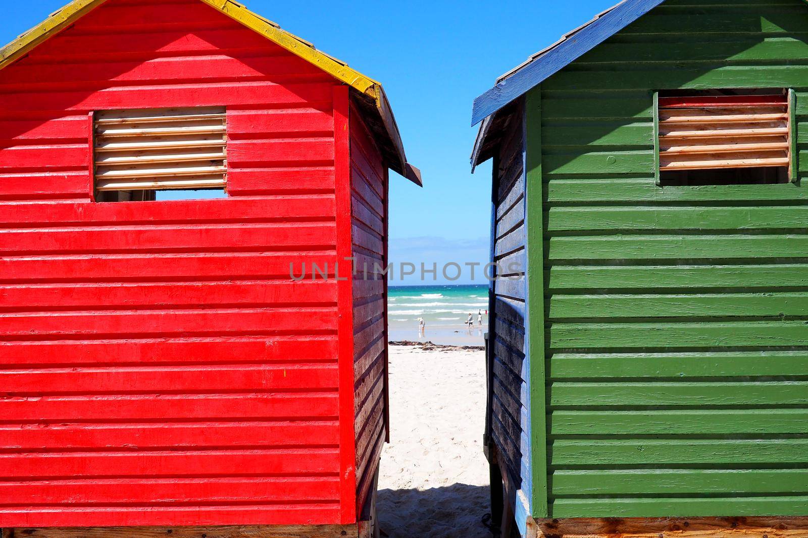 Row of colored beach huts by fivepointsix