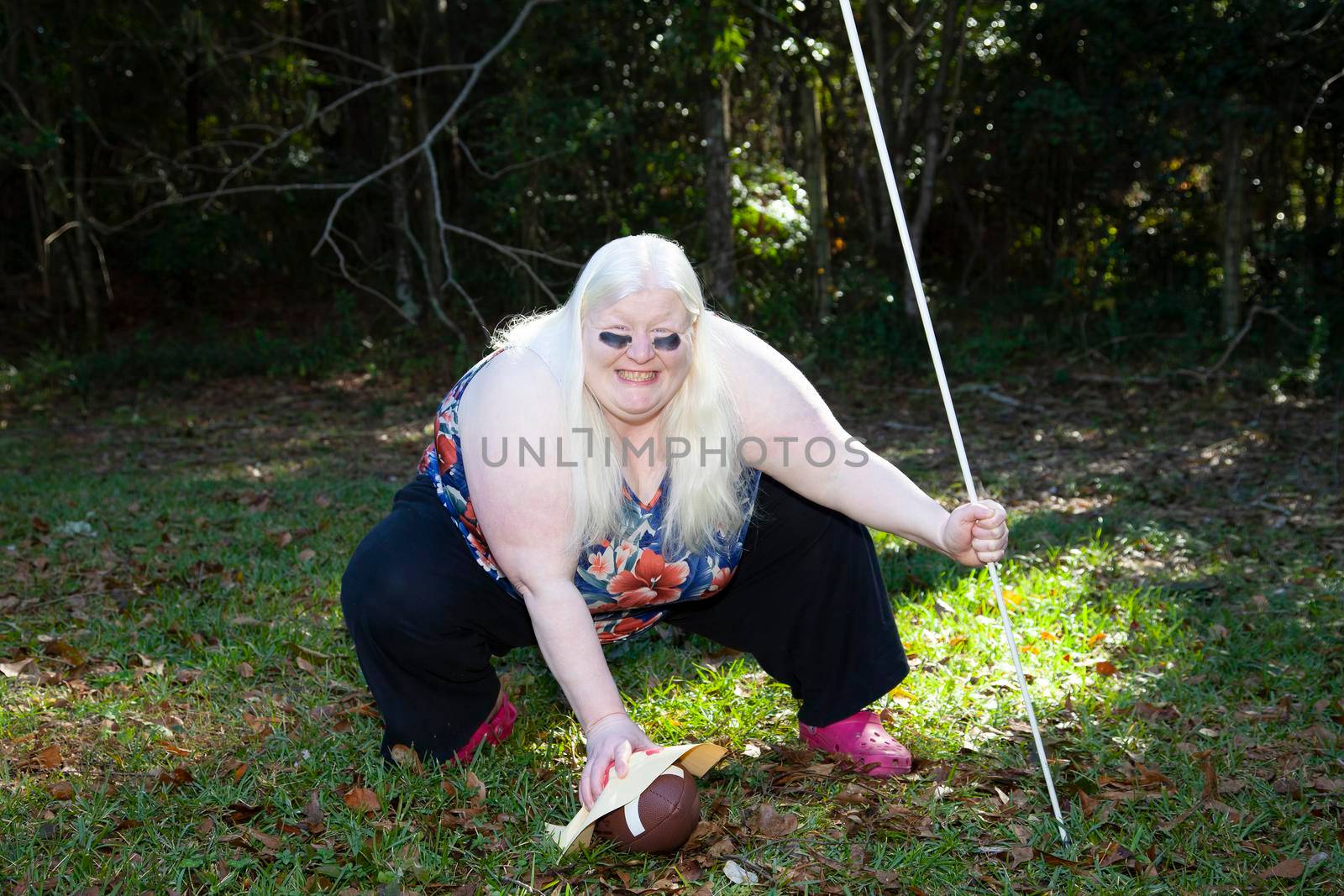 Blind woman preparing to hike a football wrapped in a paper hand-turkey
