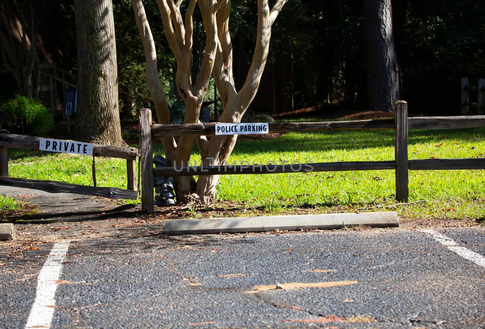 White and black police parking sign on a wooden fence