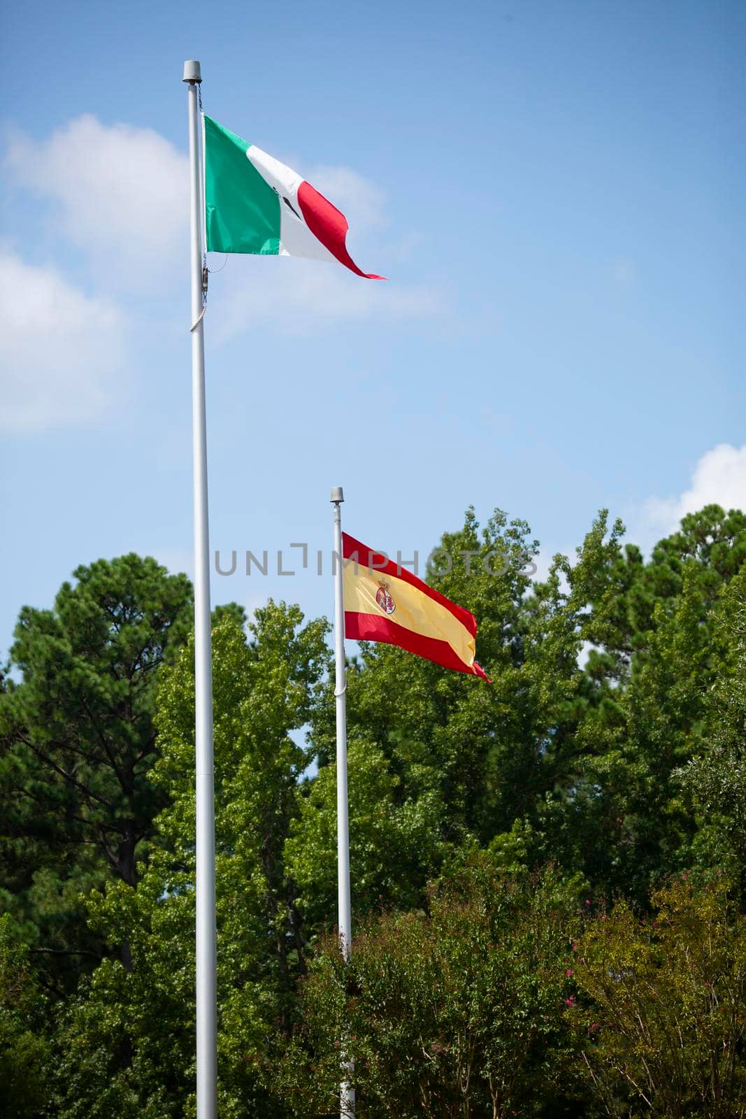 Mexican and Spanish national flags waving in the wind
