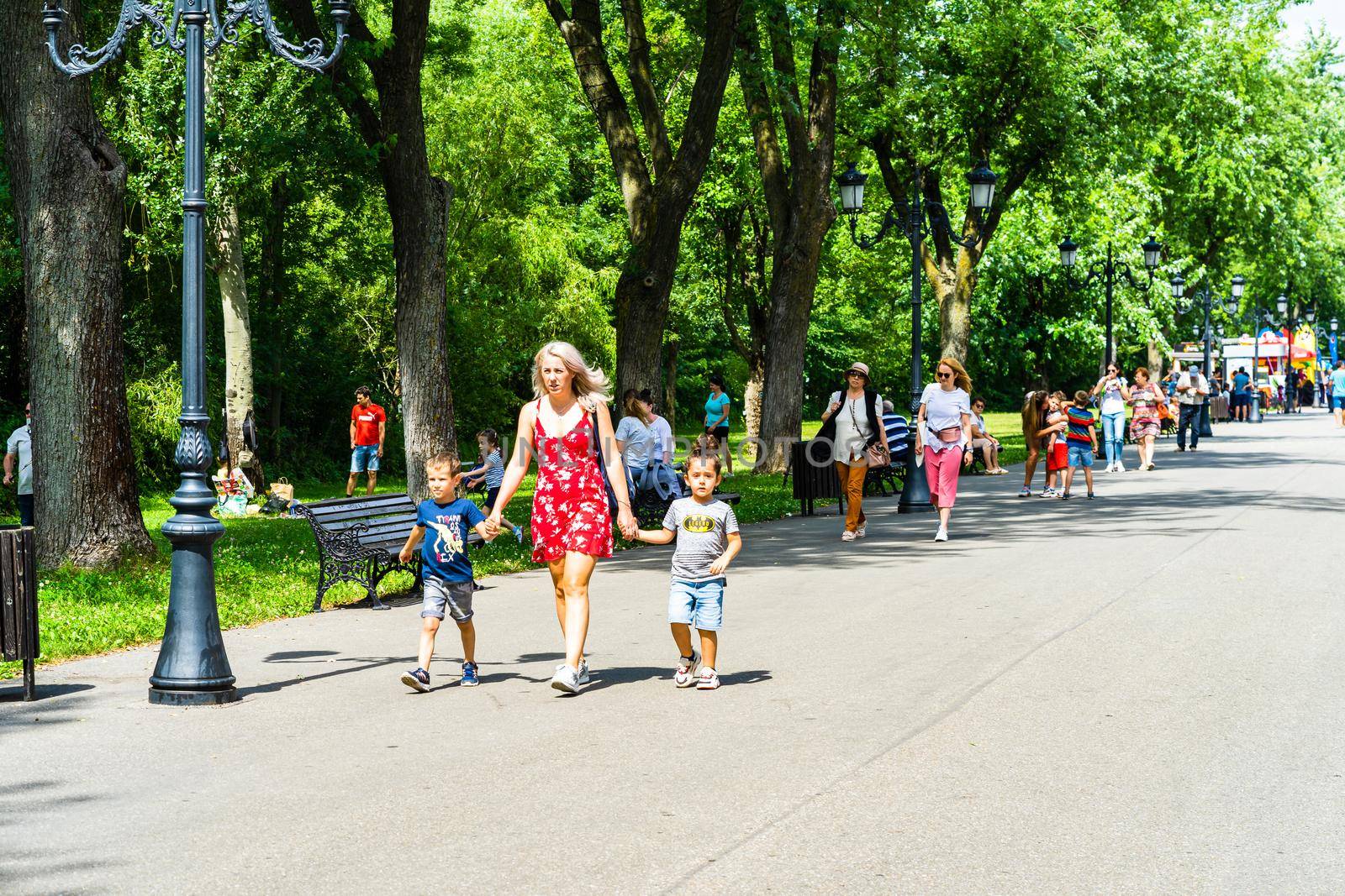 People walking, relaxing and have fun on the alleys of park and gardens of the domain from Mogosoaia in Bucharest, Romania, 2020.