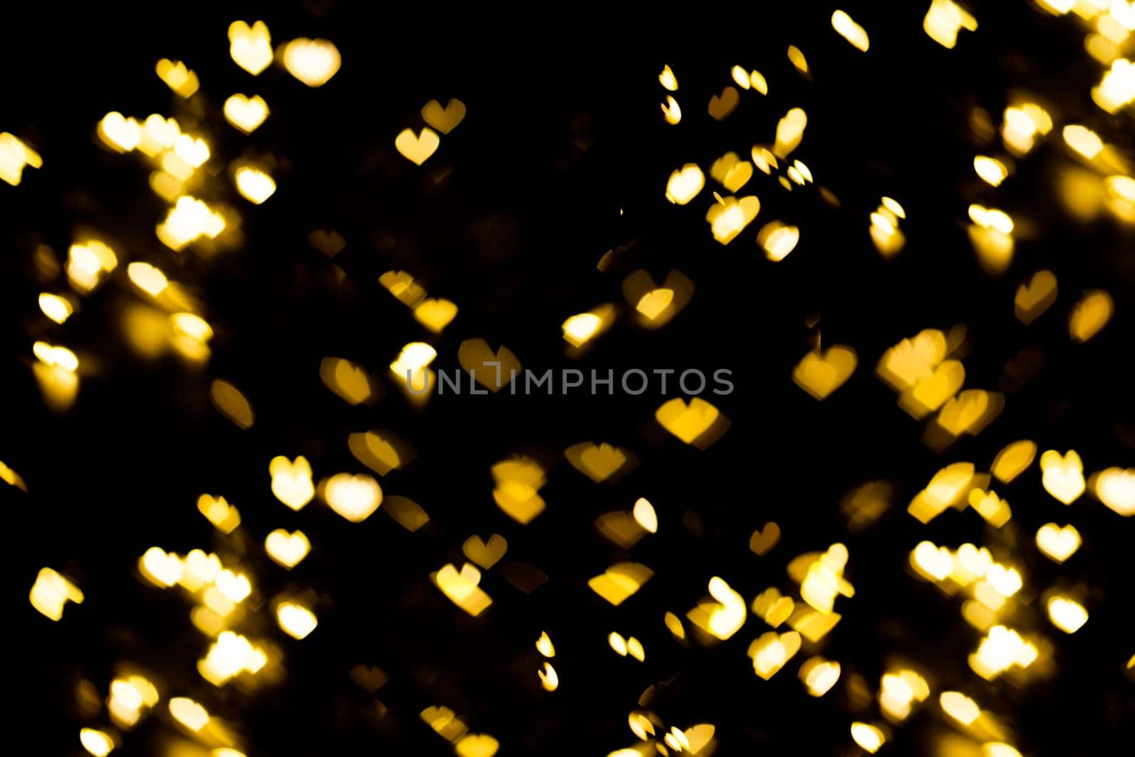 Golden shining bokeh on black background valentine day or christmas background. by galinasharapova