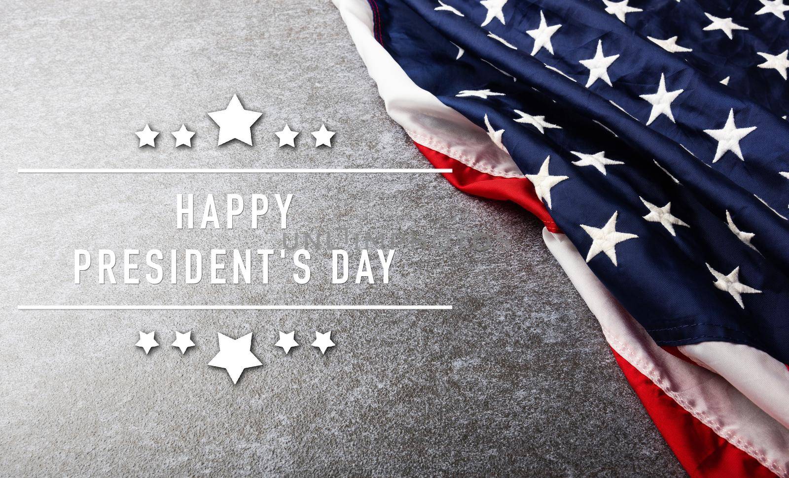 United States National Holidays. American or USA Flag with "HAPPY PRESIDENT'S DAY" text on cement background, President Day concept