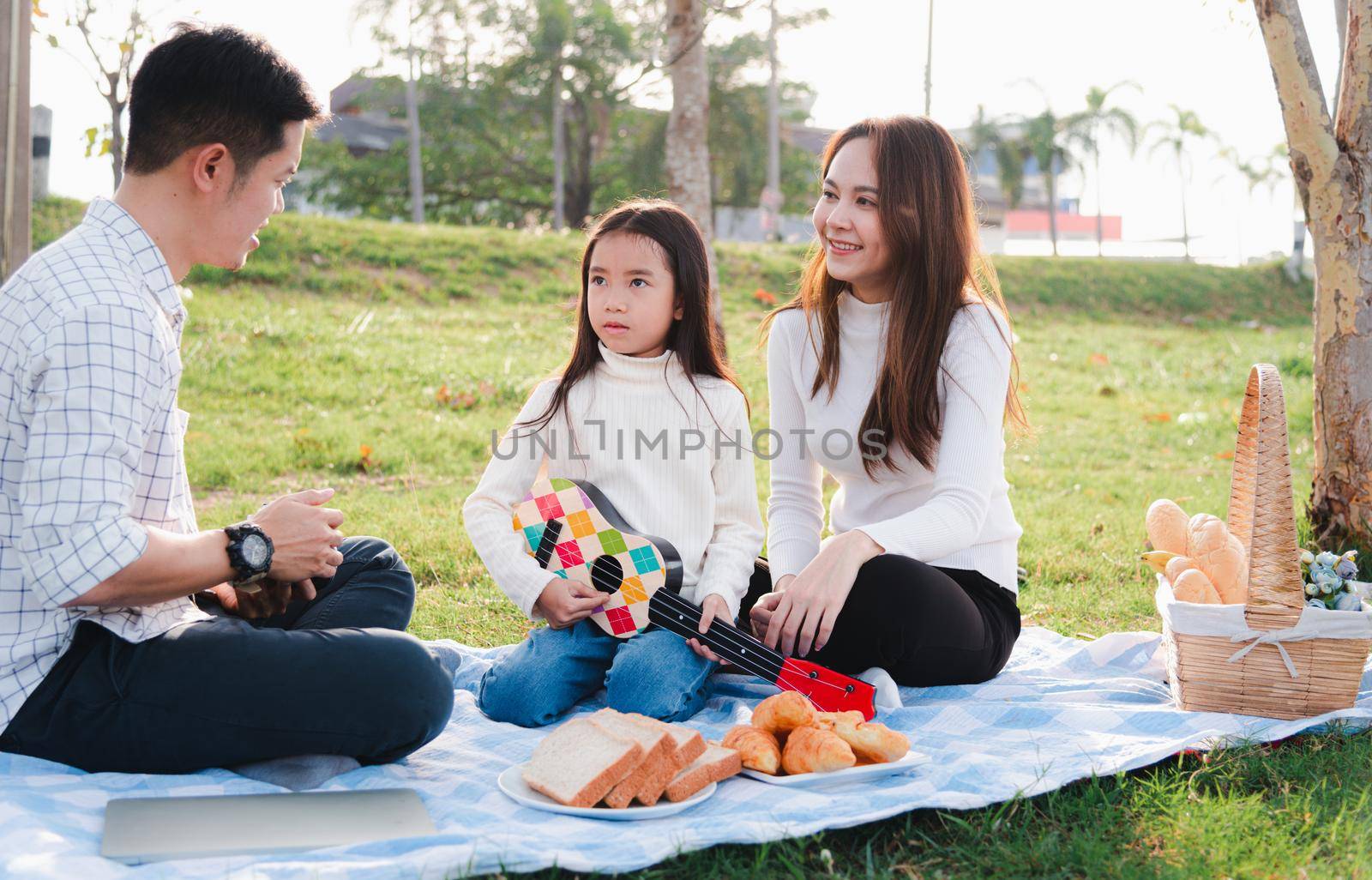 young family father, mother and children having fun and enjoying outdoor together by Sorapop