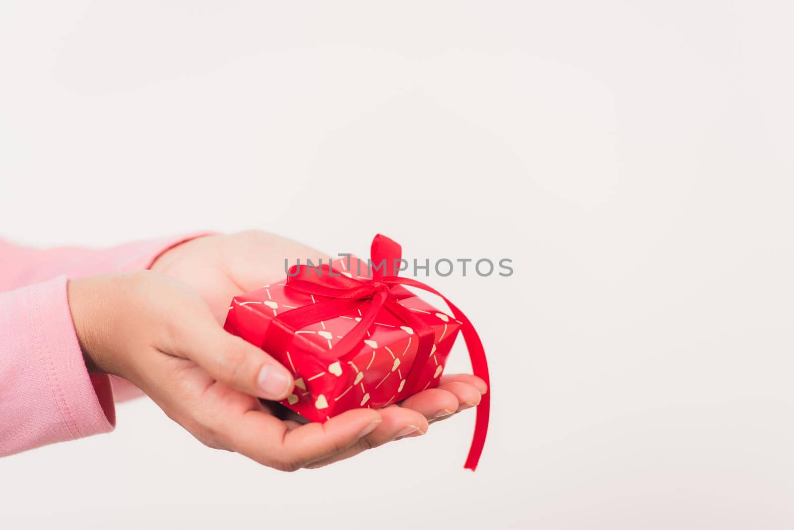 Valentine Day. Woman beauty hands holding small gift package box present wrapped paper with ribbon, Christmas, New year, Birthday holiday background concept