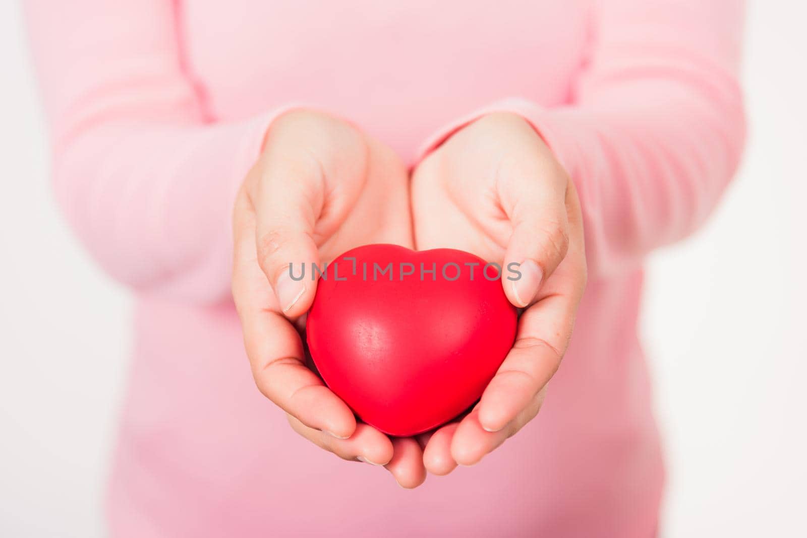 Love Valentine's Day. Woman beauty hands holding red heart for giving help donation medical healthcare concept isolated on white background, holiday background concept