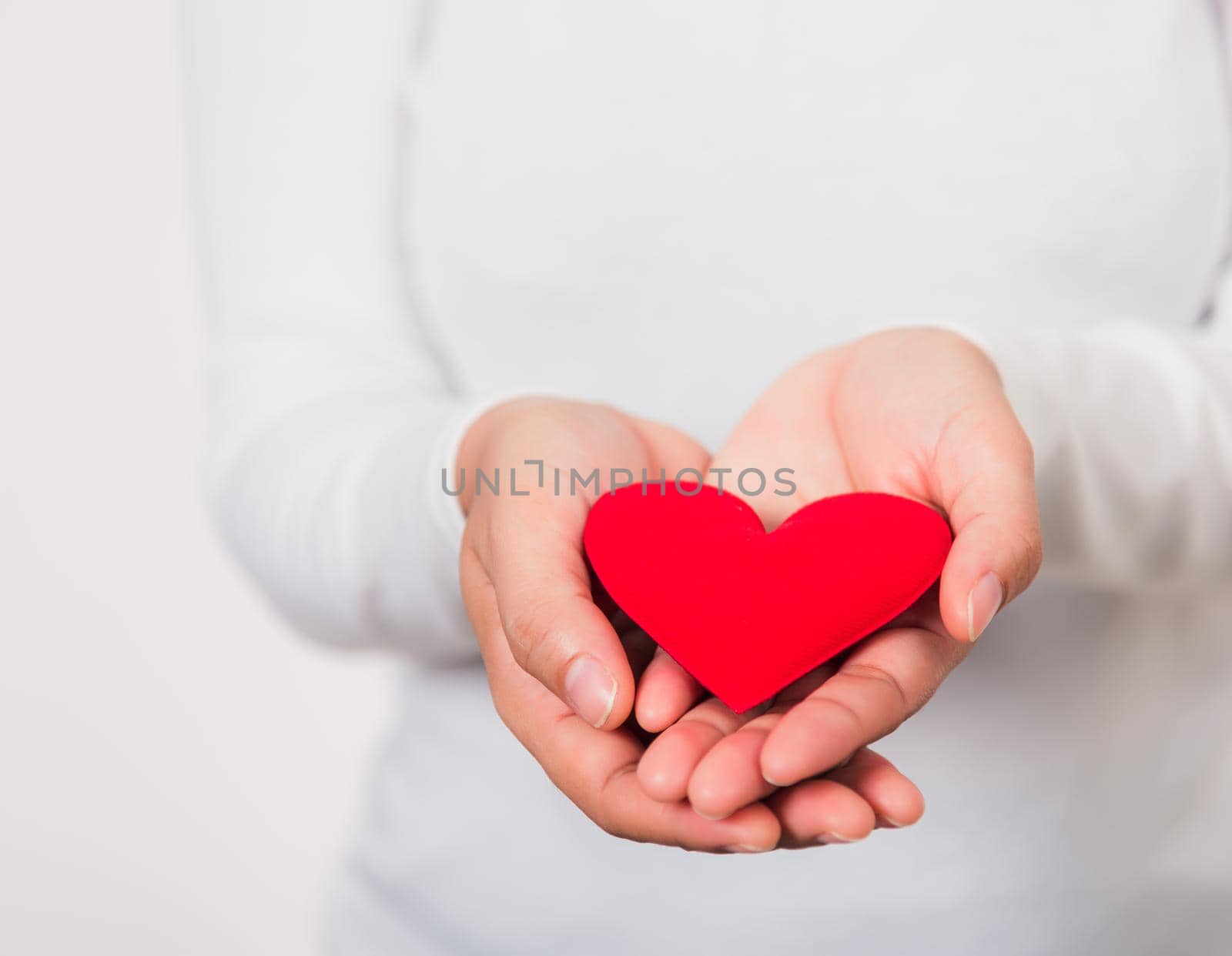 Love Valentine's Day. Woman beauty hands holding red heart for giving help donation medical healthcare concept isolated on white background, holiday background concept