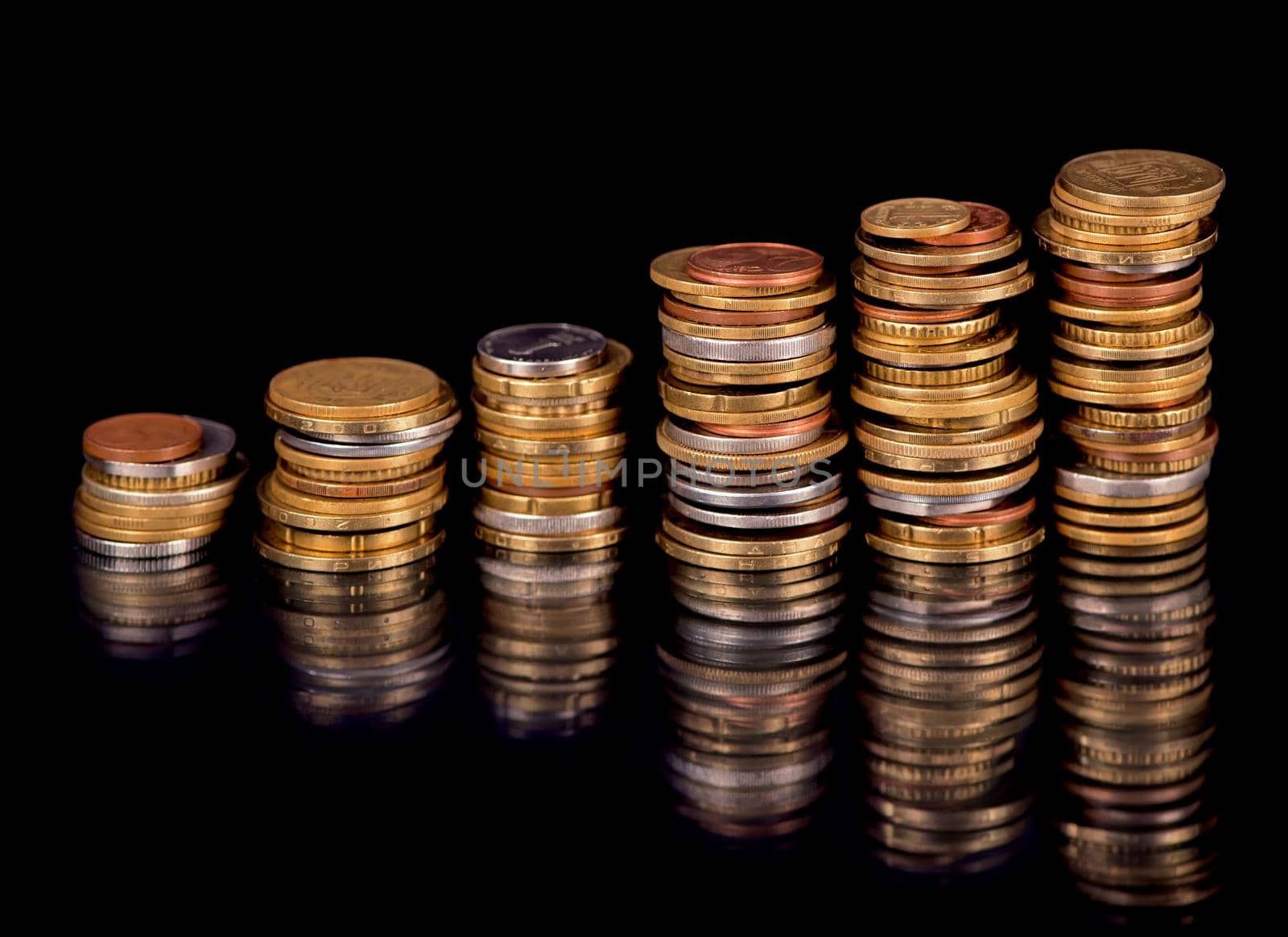 Stacks cf different country coins on black by aprilphoto