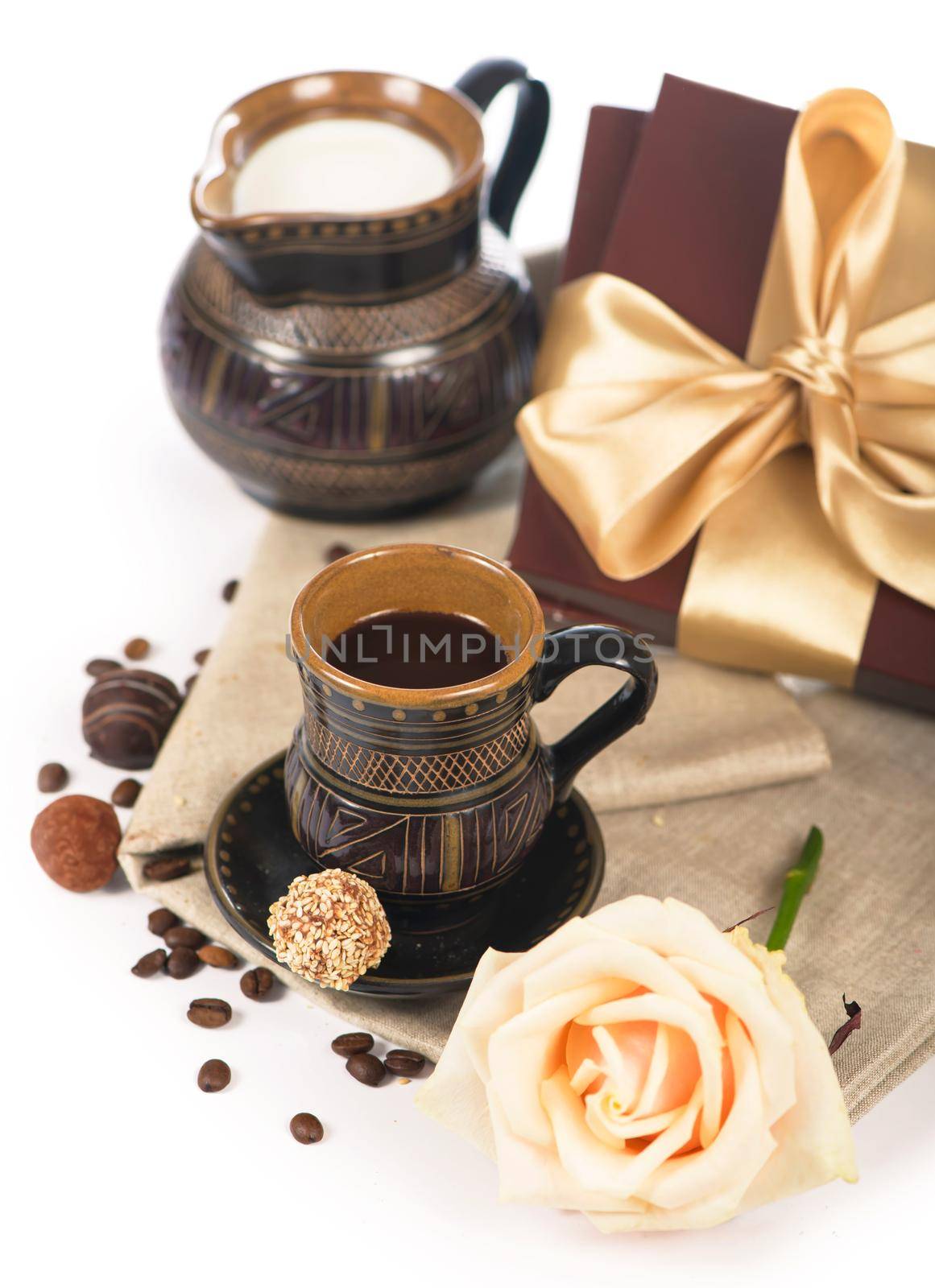 old black pottery, coffee beans, candy and a cup of drink by aprilphoto